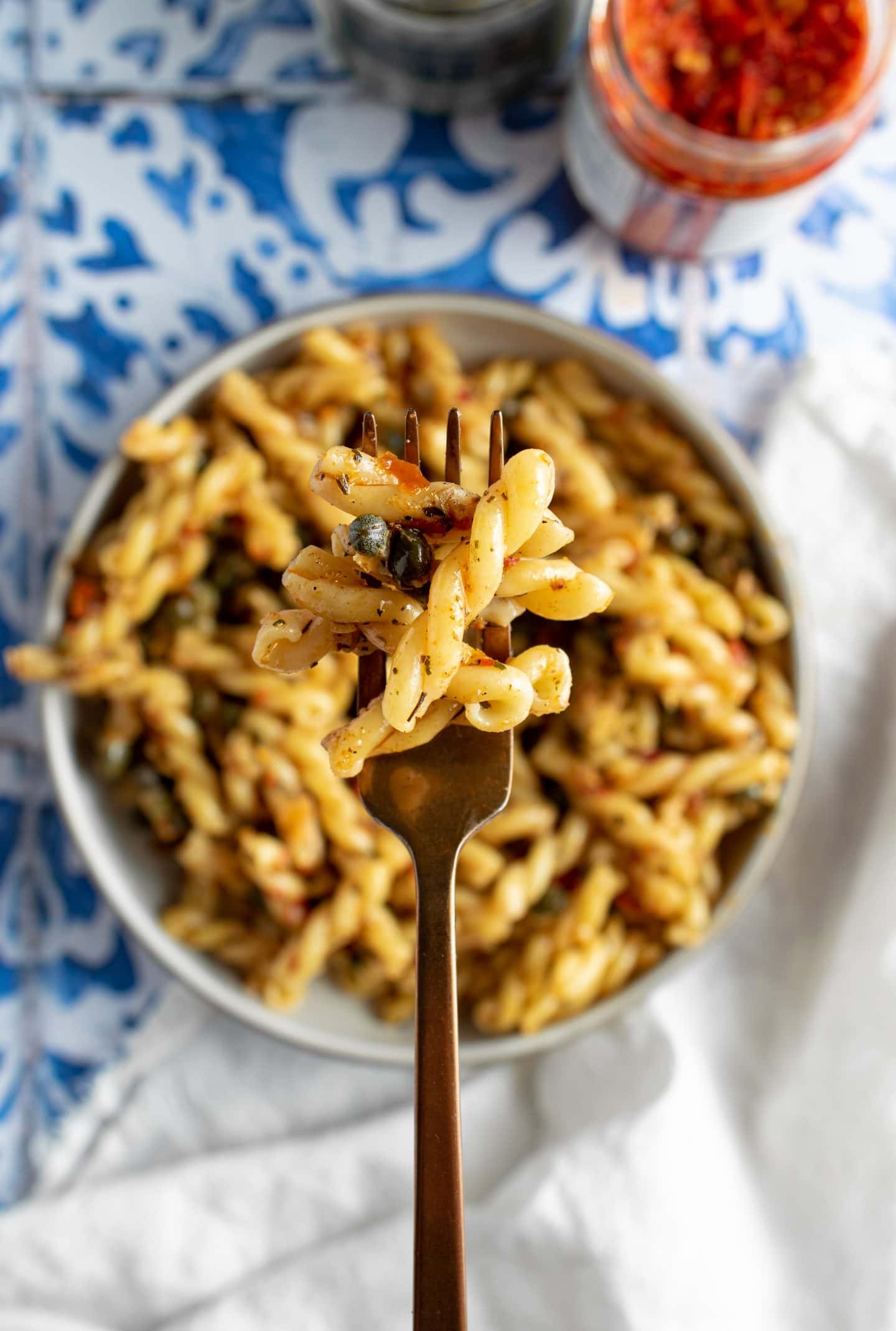 spicy caper pasta on a fork
