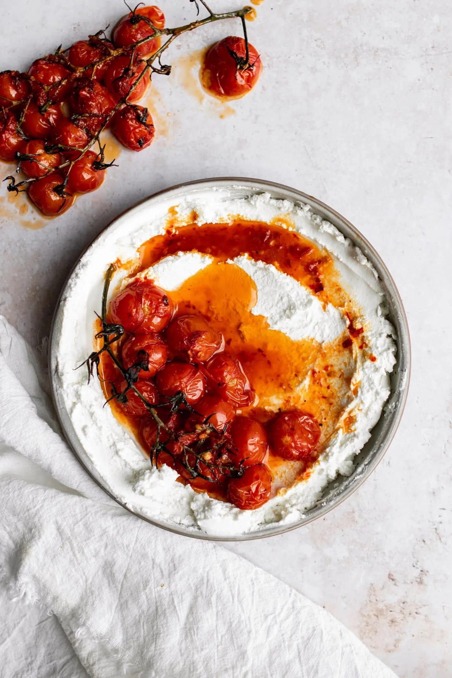 bowl of labneh with harissa roasted tomatoes