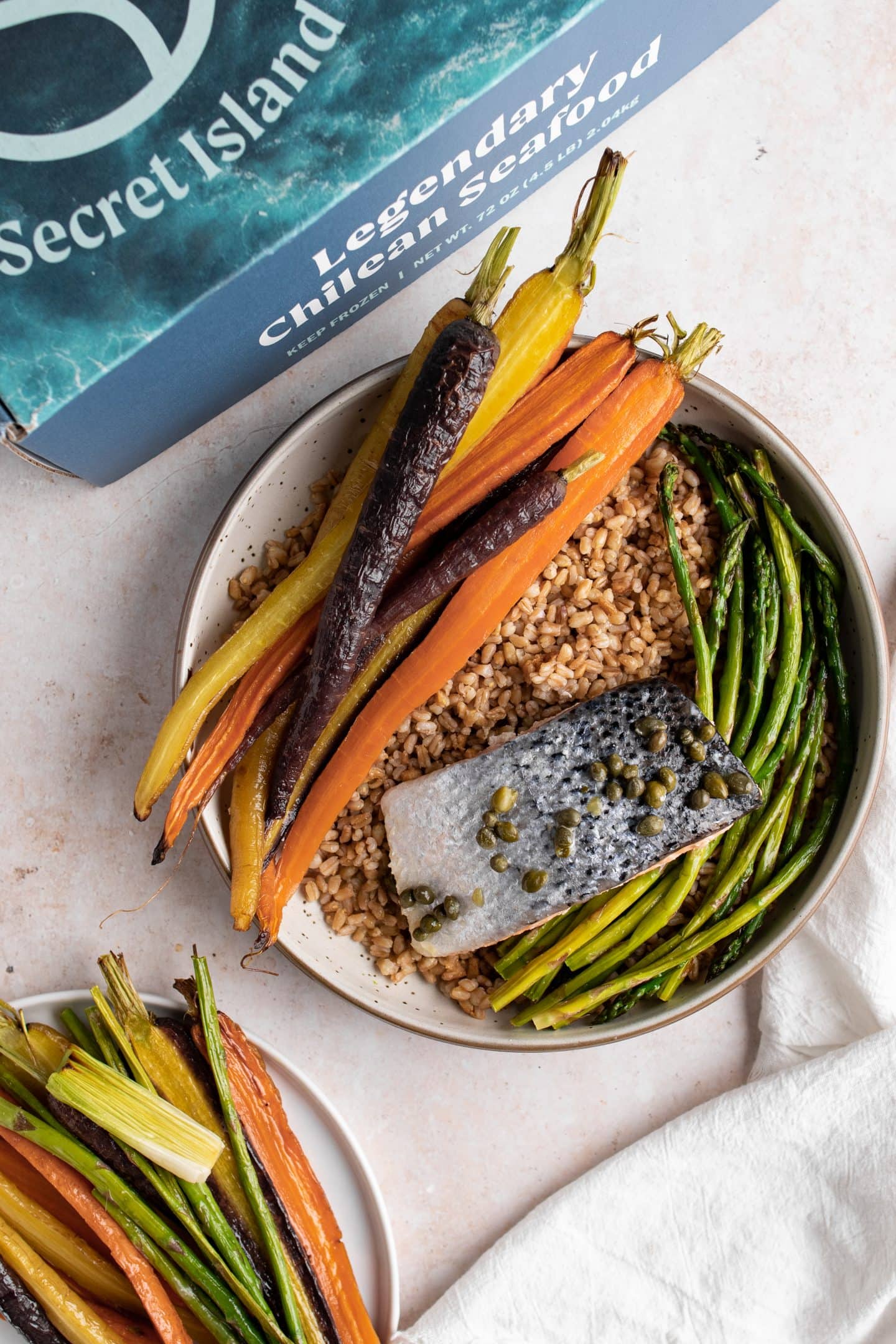 composed grain bowl of lemon caper salmon with roasted vegetables