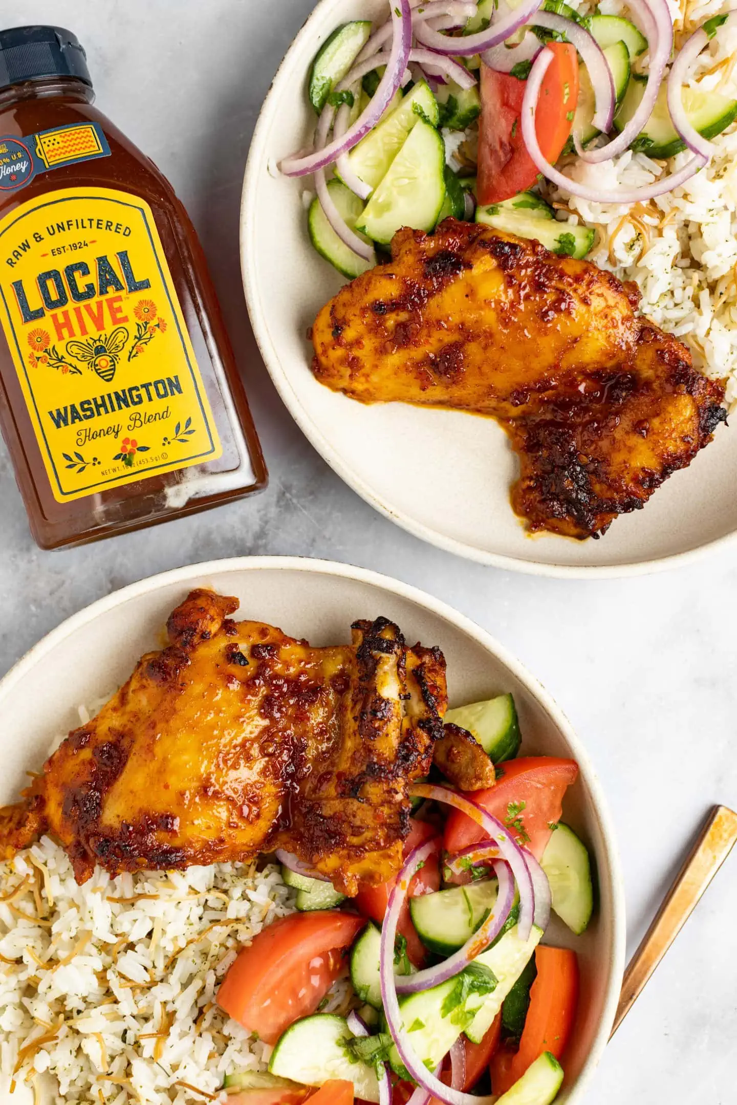 2 bowls of harissa honey chicken with local hive honey bottle