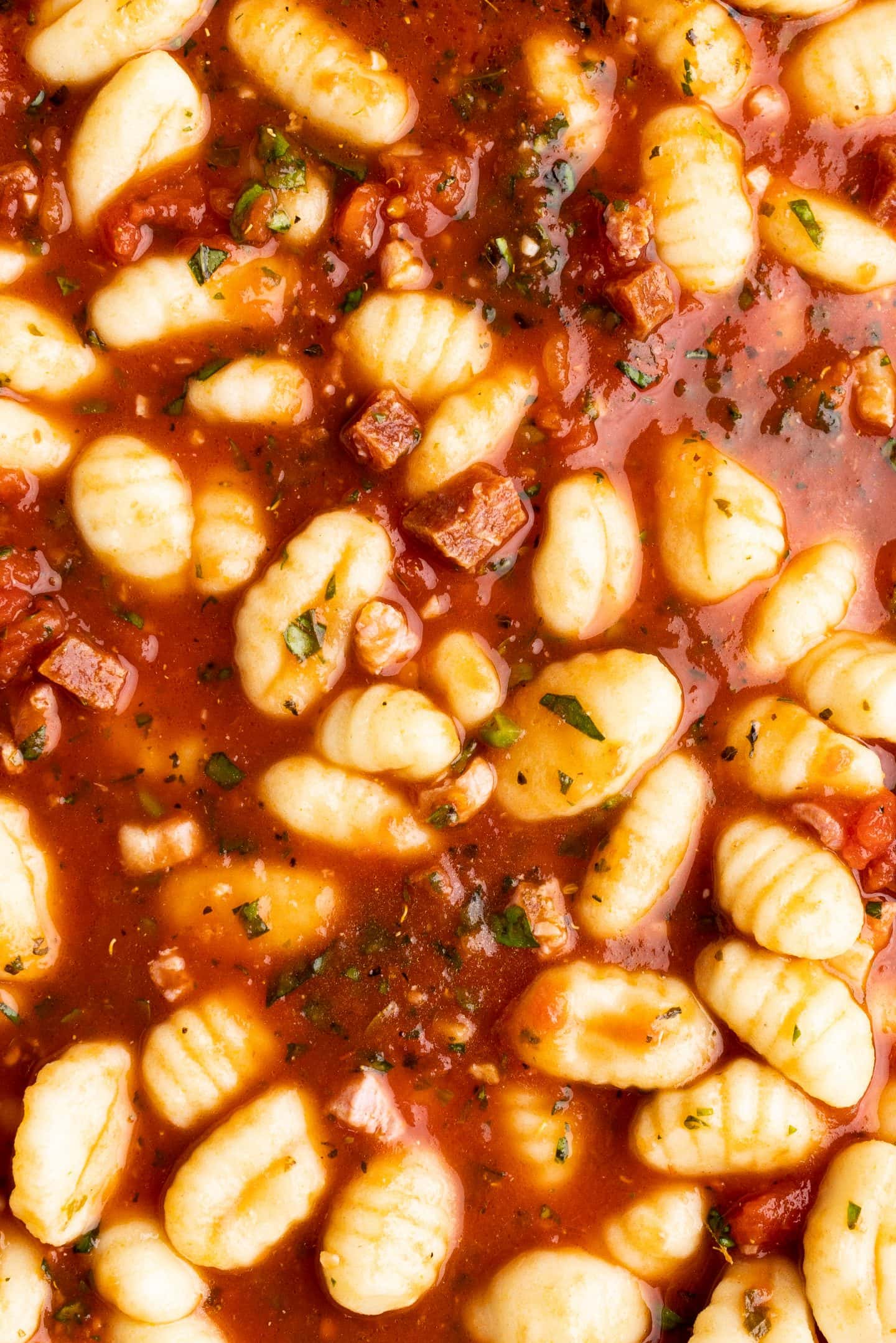 gnocchi summered in sauce before cheese and baking