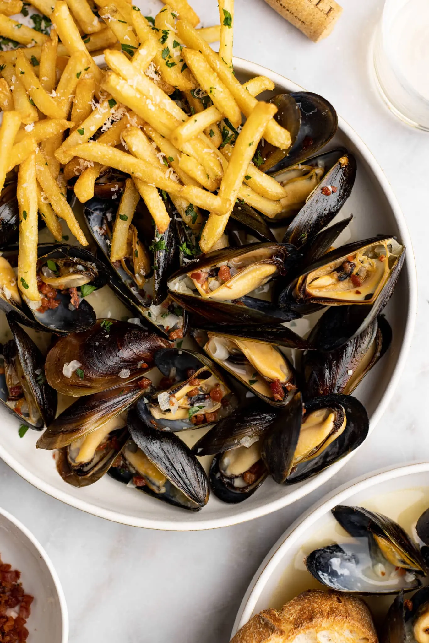 up close moules frites in a pancetta wine sauce