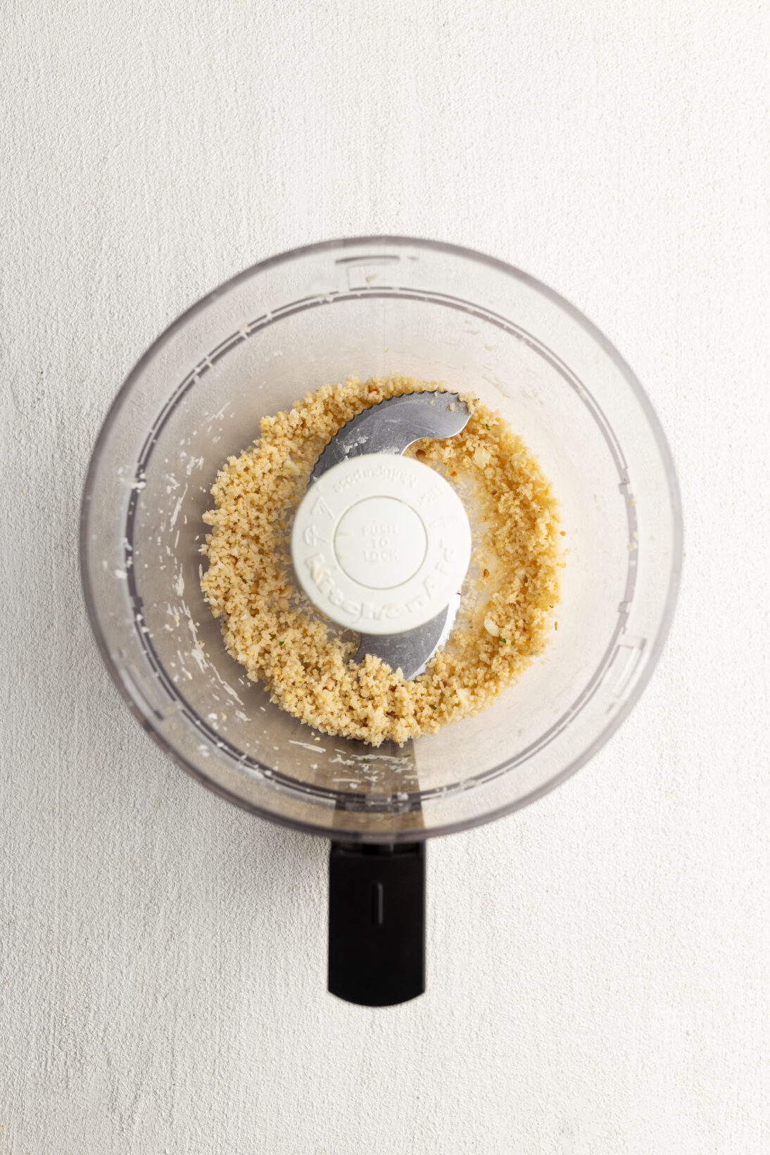 Step by Step: breaking down the pine nuts, parm, and garlic first.