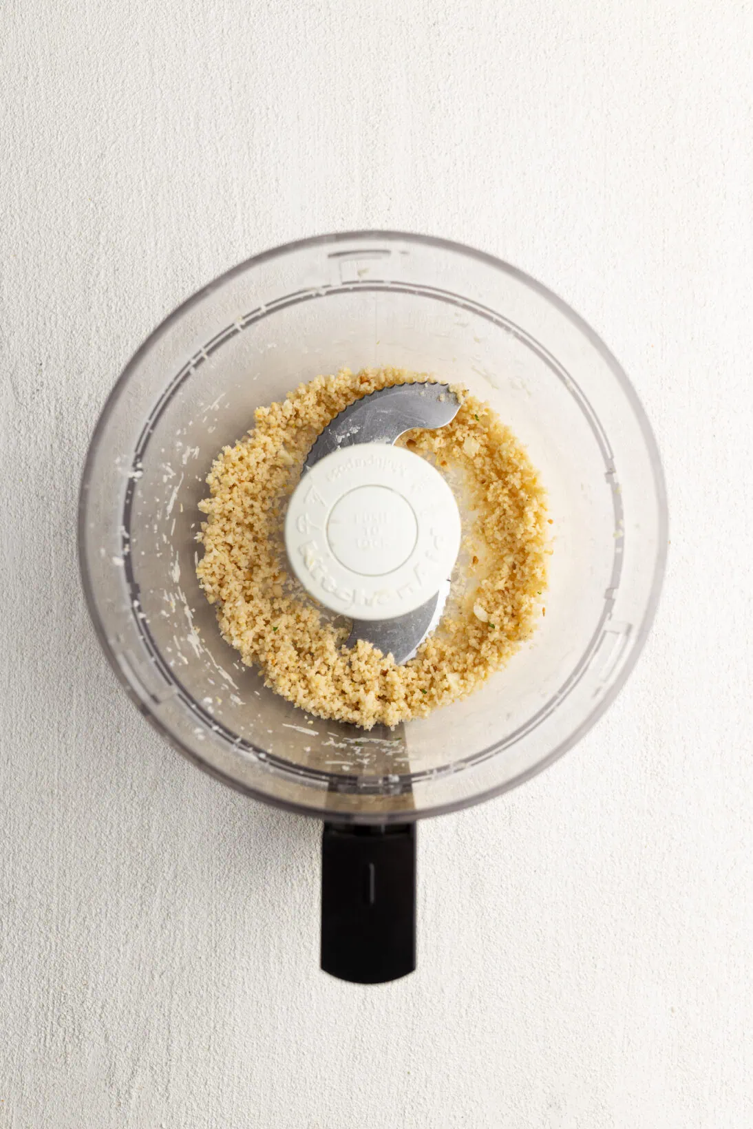 Step by Step: breaking down the pine nuts, parm, and garlic first.