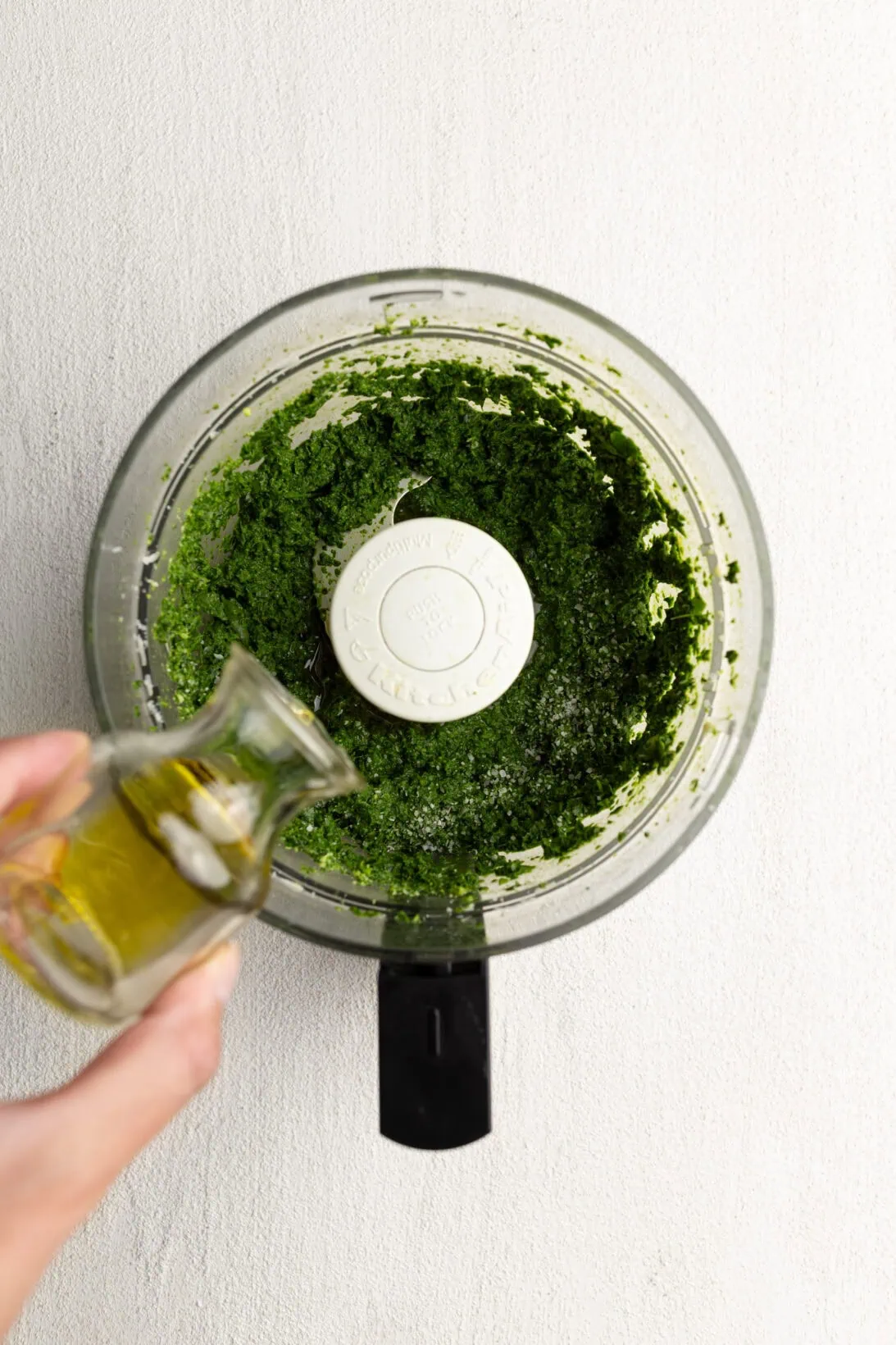 Step by Step: Adding in olive oil to the sauce.