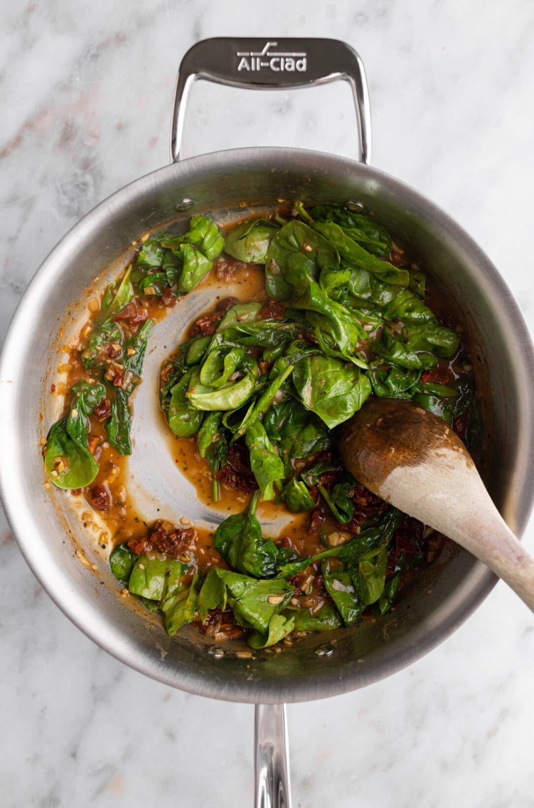 adding spinach to the sauce