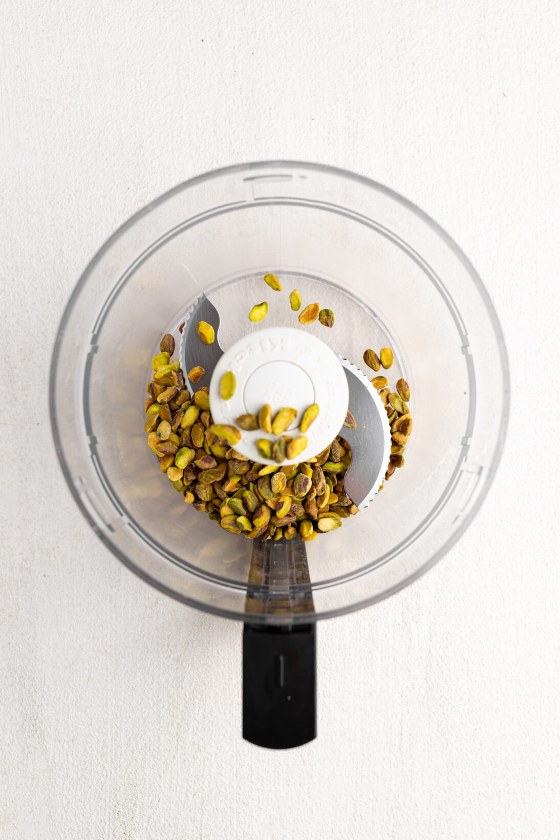 food processor; whole roasted pistachios