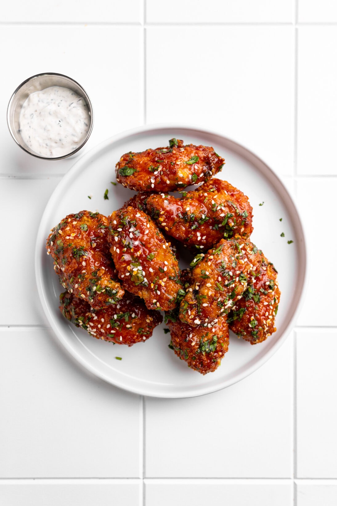 plate of gochujang wings next to the furikake ranch