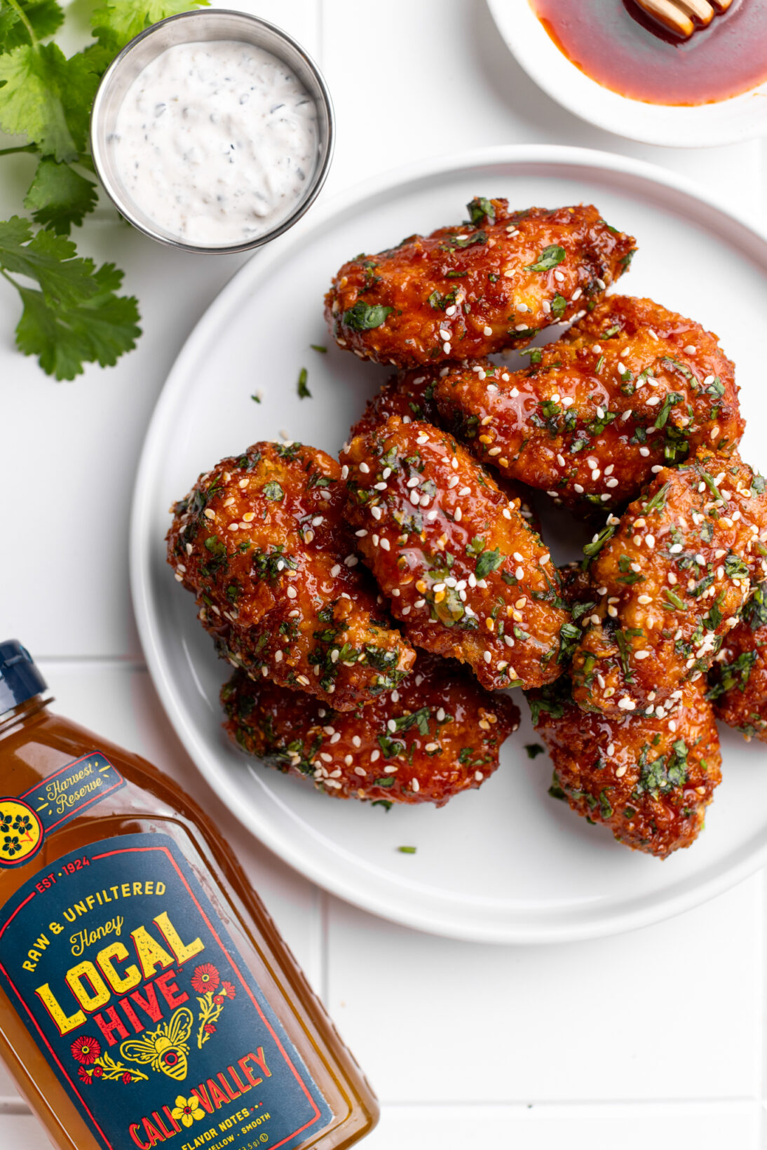 plate of gochujang wings next to the furikake ranch