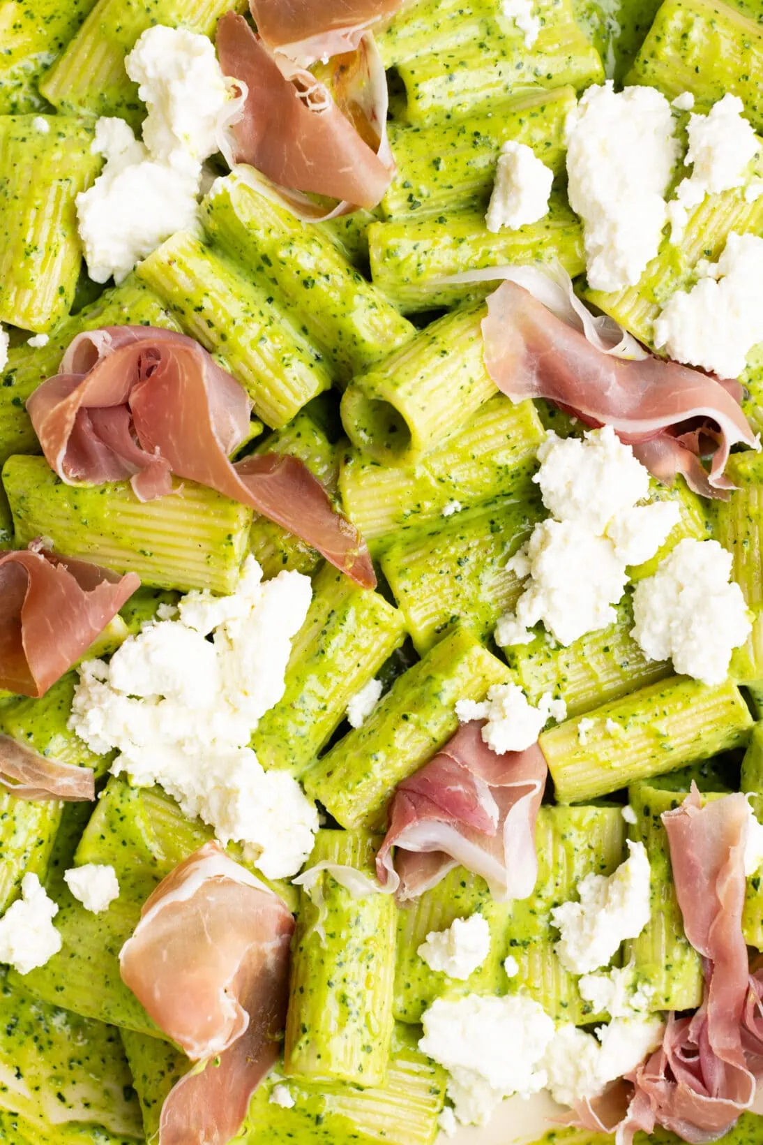 creamy kale pesto pasta over rigatoni topped with fresh ricotta and prosciutto. 