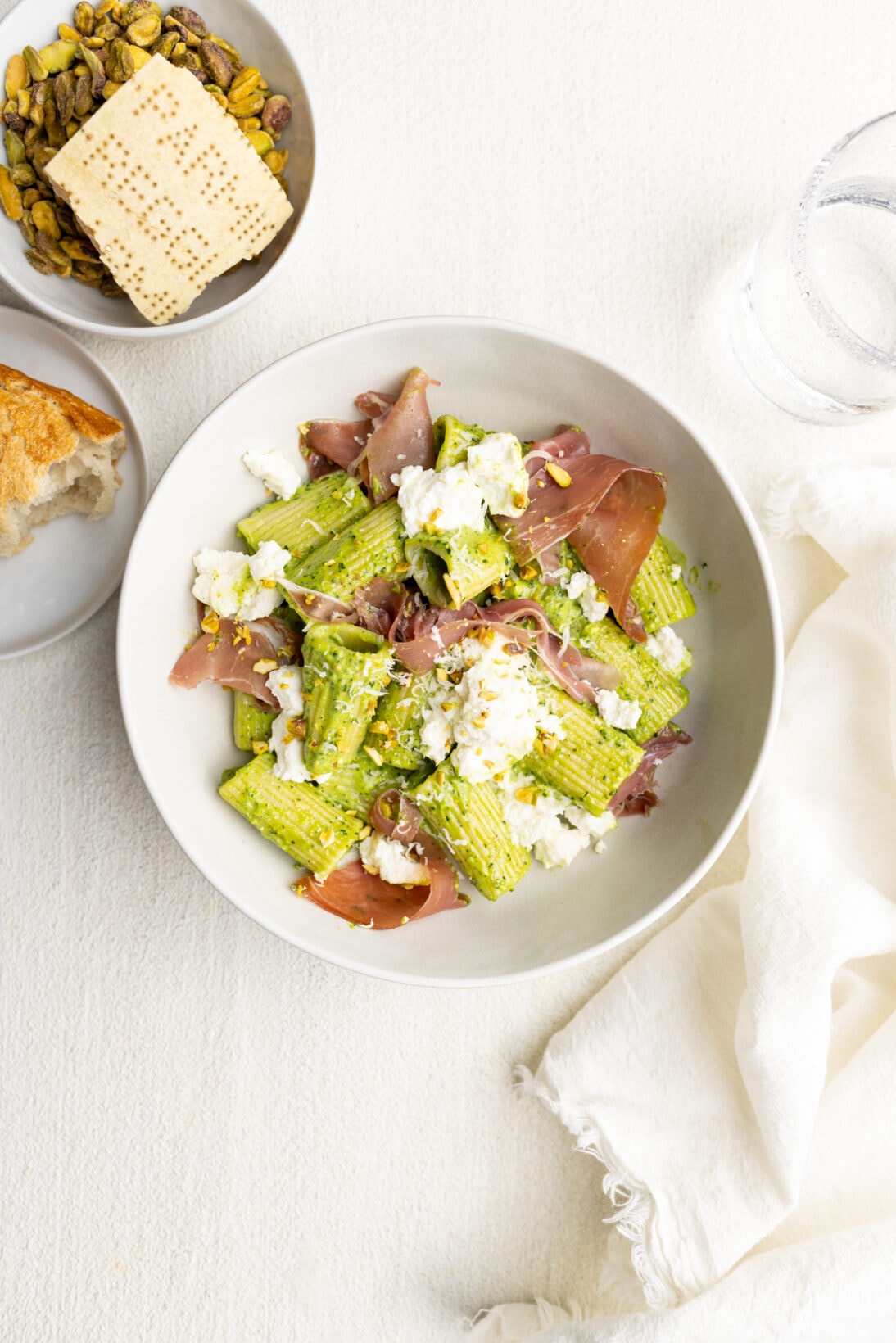 creamy kale pesto pasta over rigatoni topped with fresh ricotta and prosciutto.