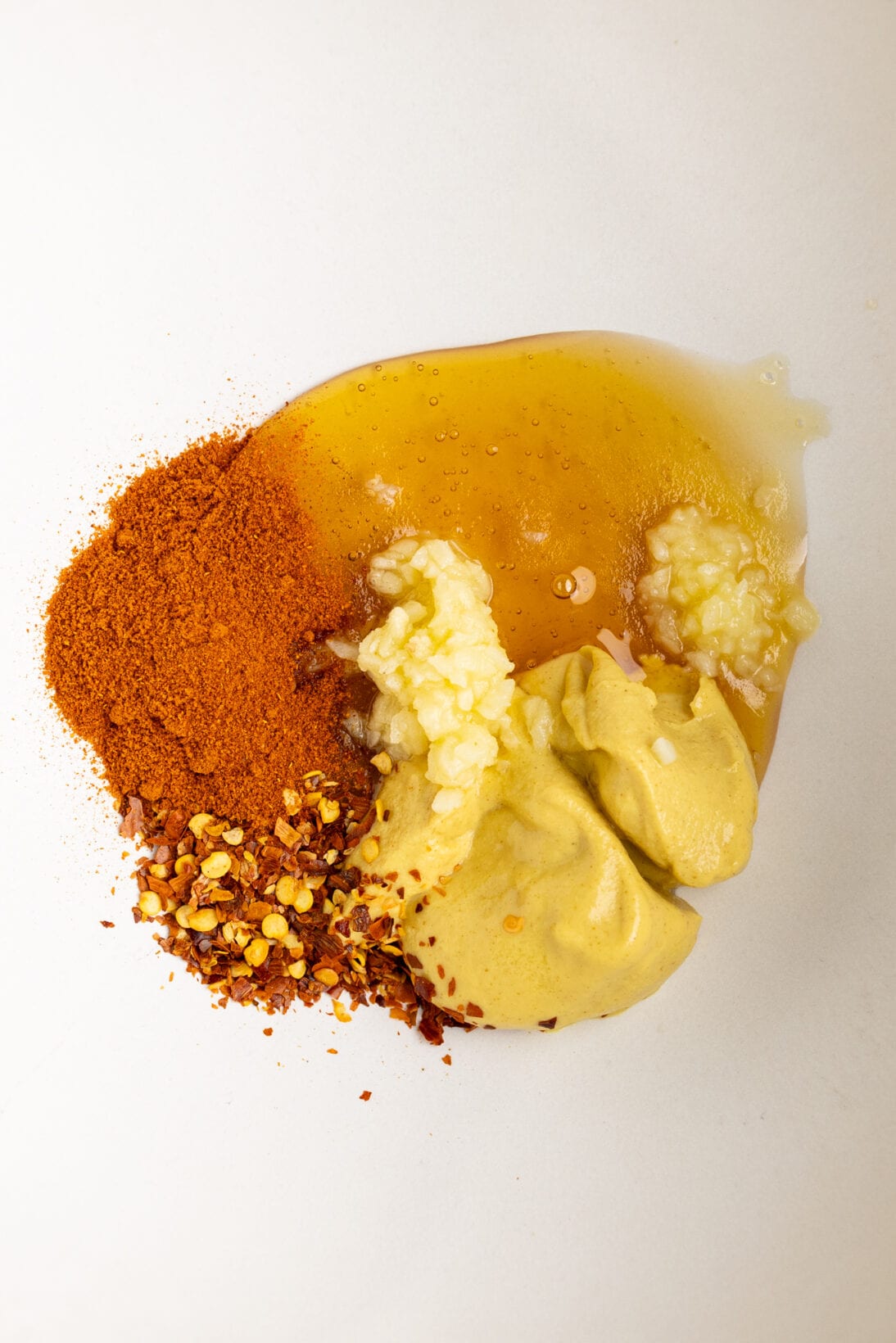 ingredients for the honey mustard sauce - Dijon mustard, honey, chili flakes, paprika, and sautéed garlic with butter.