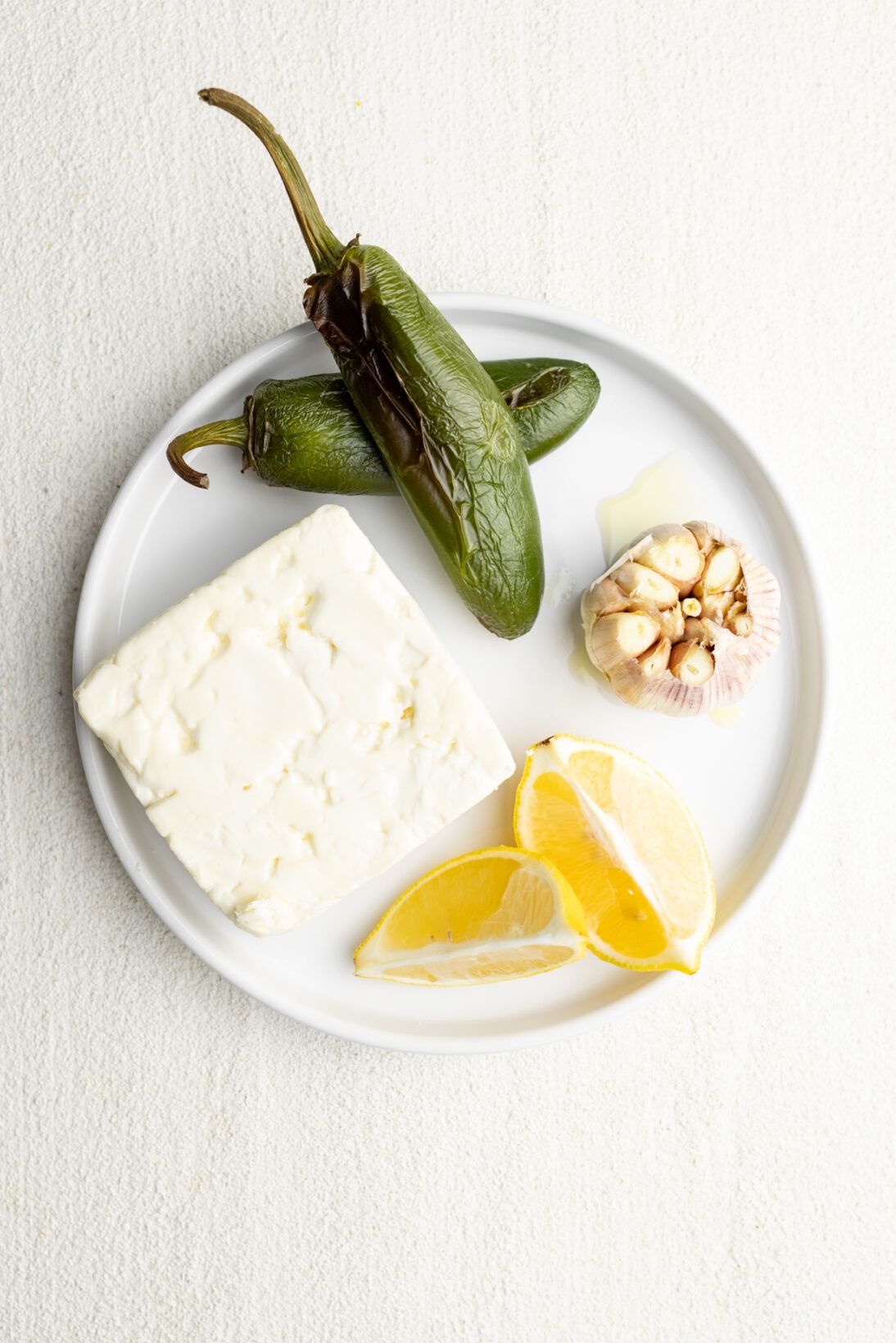 plate of ingredients, jalapeño, lemon, garlic, and feta