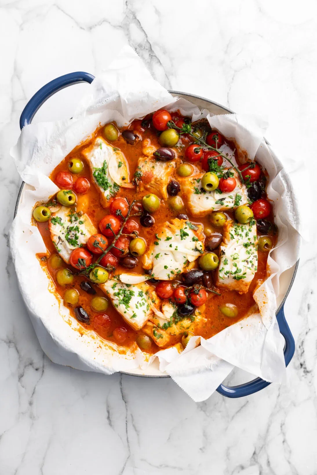 braiser with mediterranean fish - thick chunks of cod in a herb simmered red sauce with olives and tomatoes.