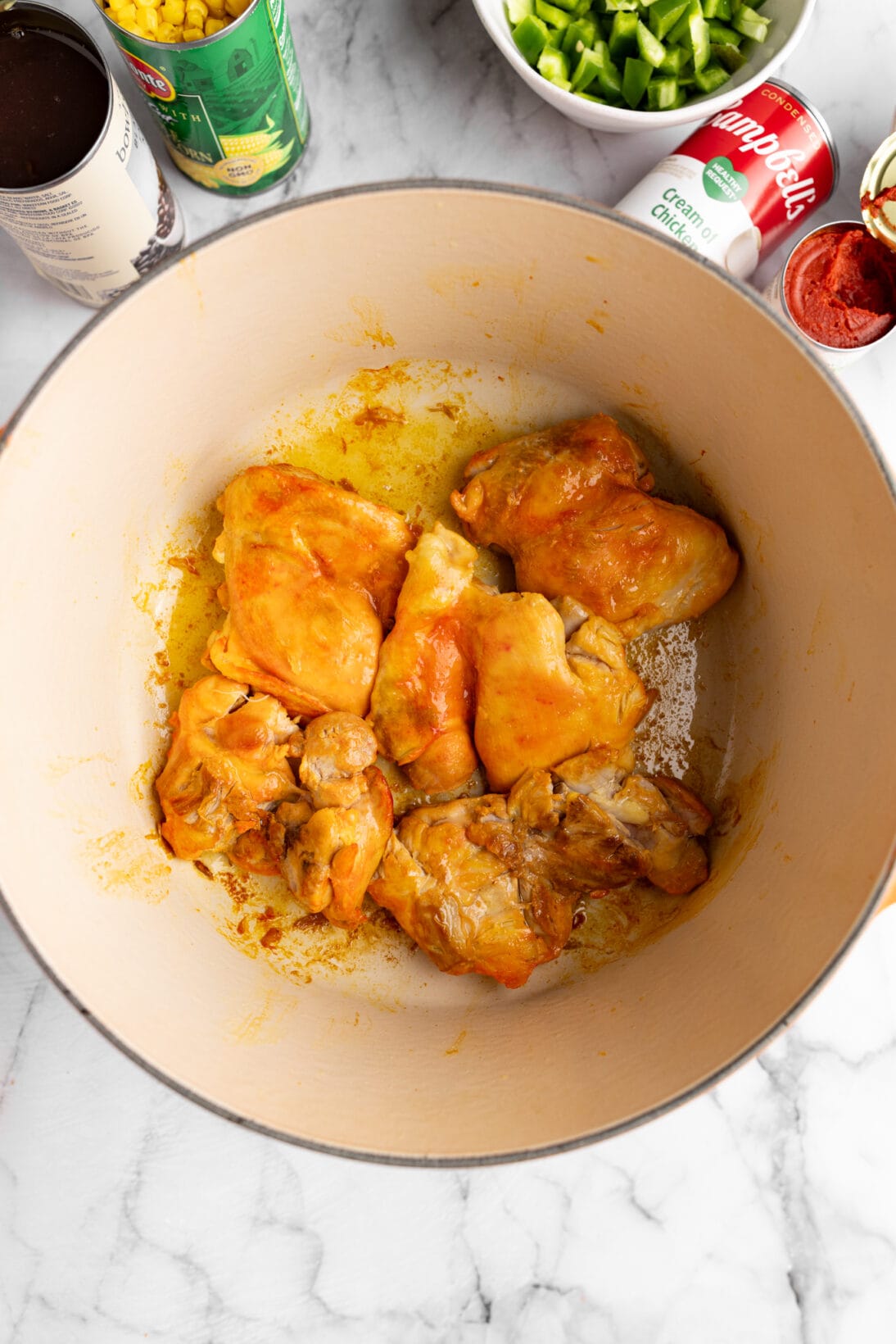 dutch oven with sazón coated chicken