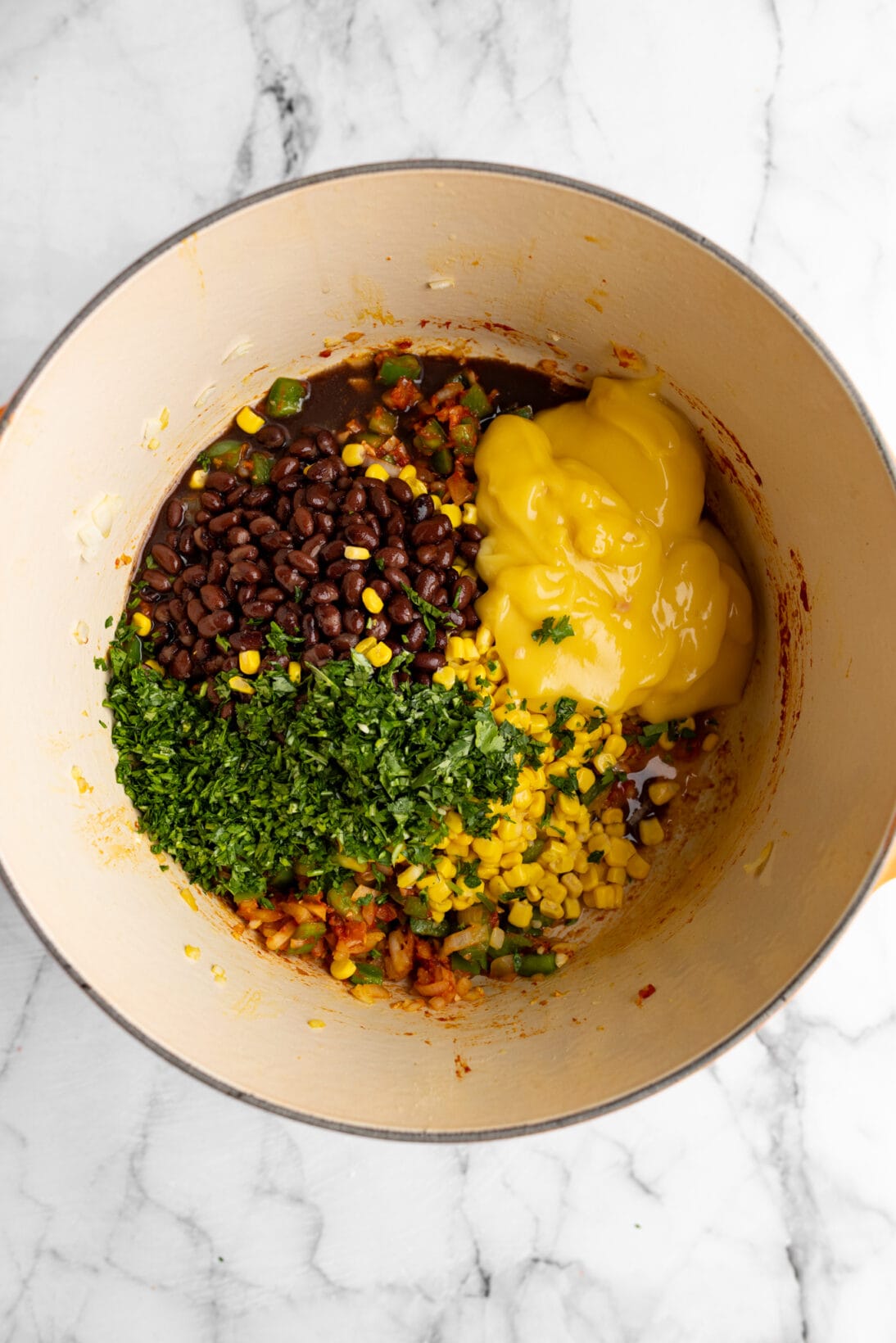 all the ingredients excluding the chicken added to the dutch oven