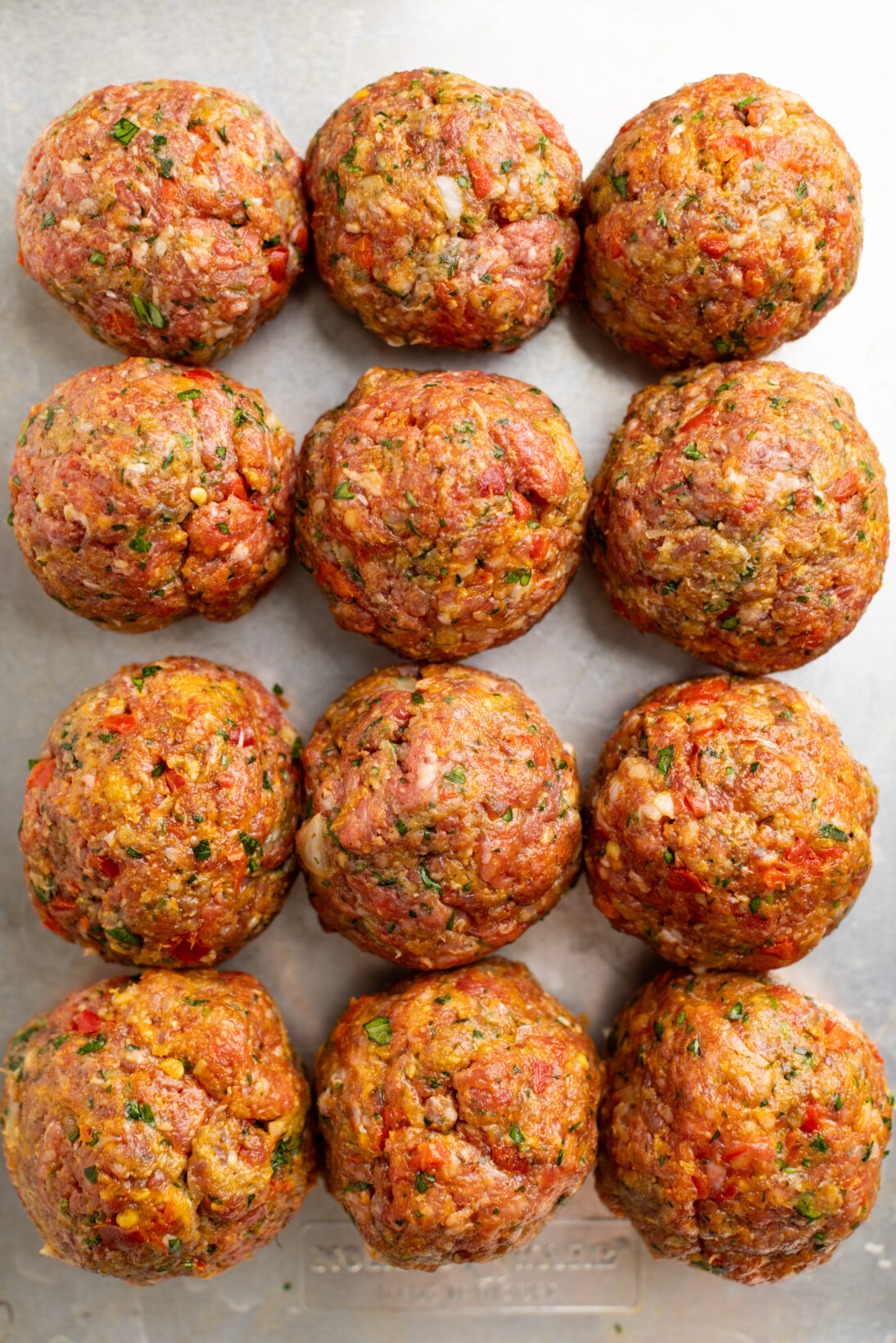 spicy meatballs formed on a sheetpan