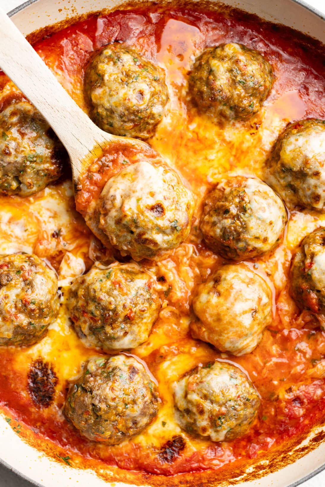 Calabrian spicy meatballs after being baked toped with cheese