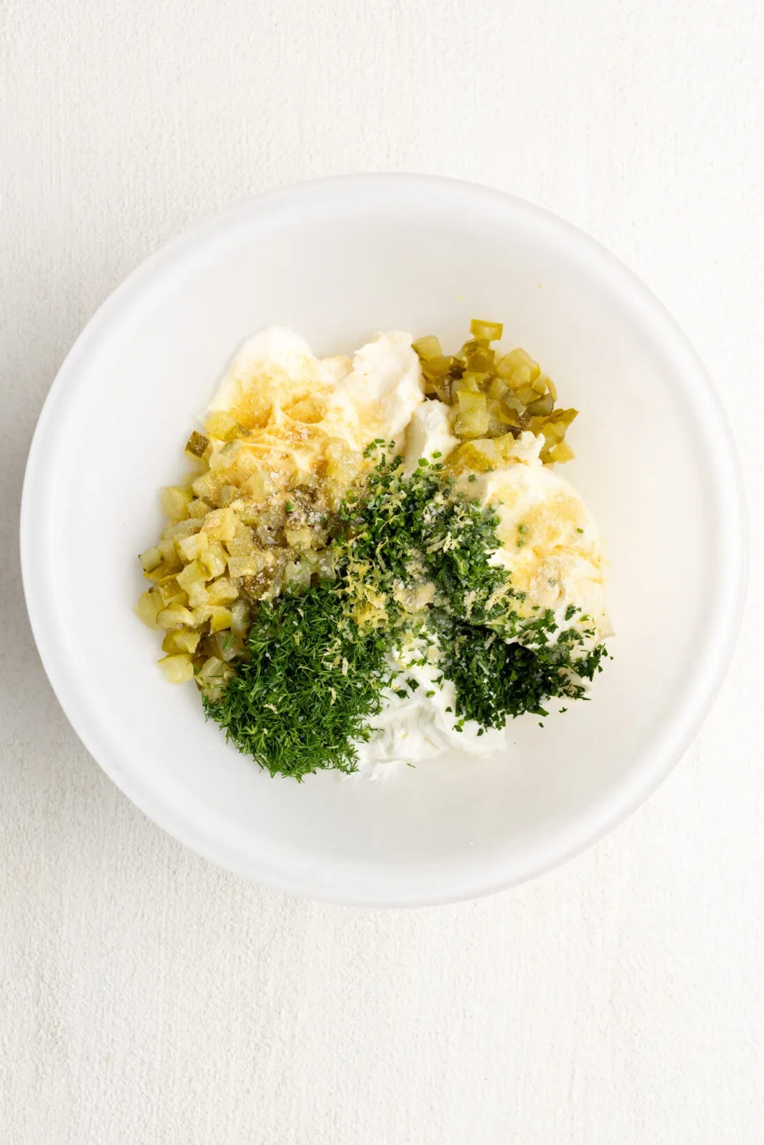 dill pickle dip ingredients in a bowl, unmixed.