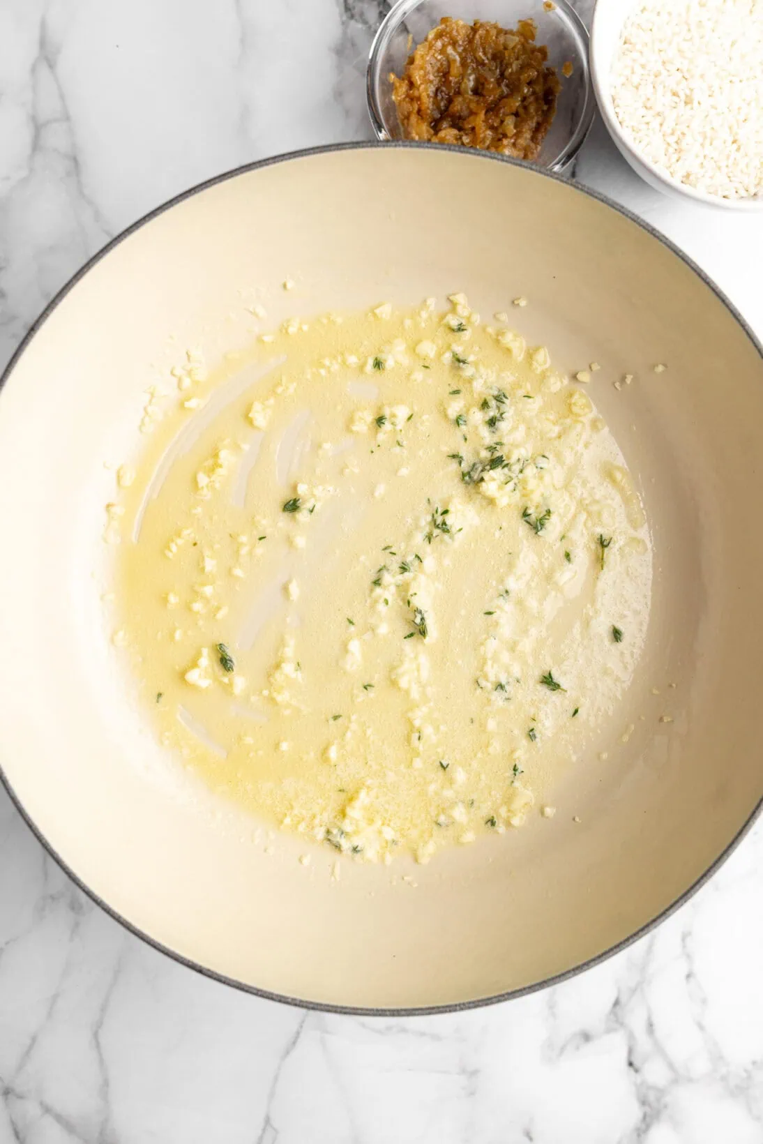 sautéing the garlic and thyme in butter
