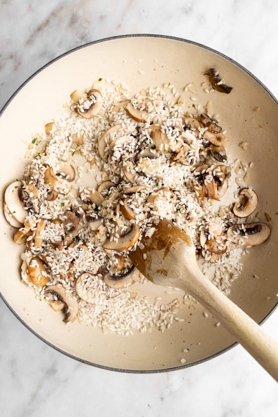 Making mushroom risotto: toasting the rice.