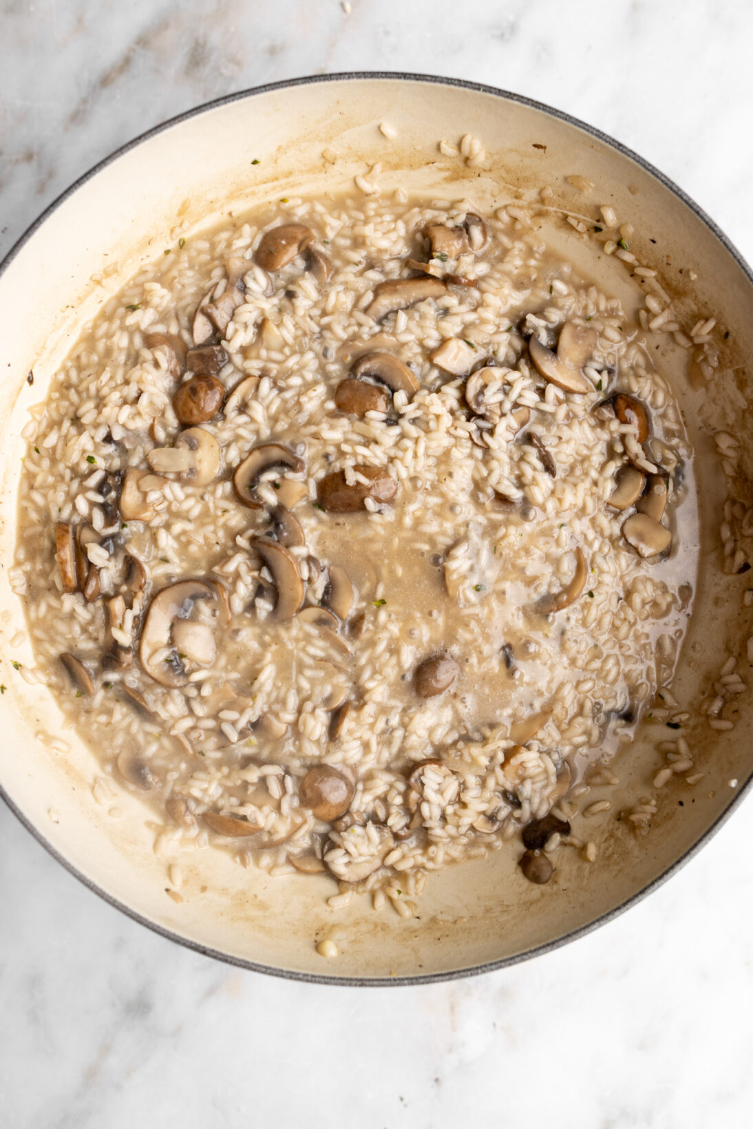 Making mushroom risotto: cooking the risotto
