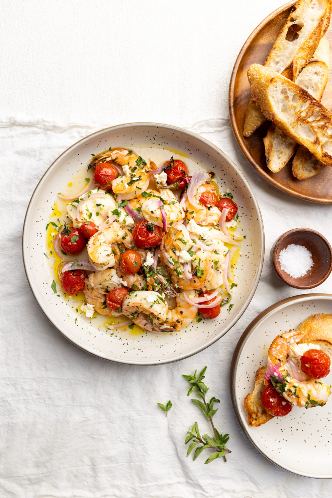 plated  Mediterranean shrimp and feta bake next to crusty bread