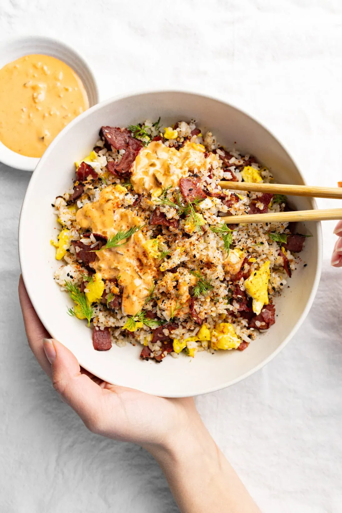 eating pastrami fried rice with a side of sriracha Russian dressing
