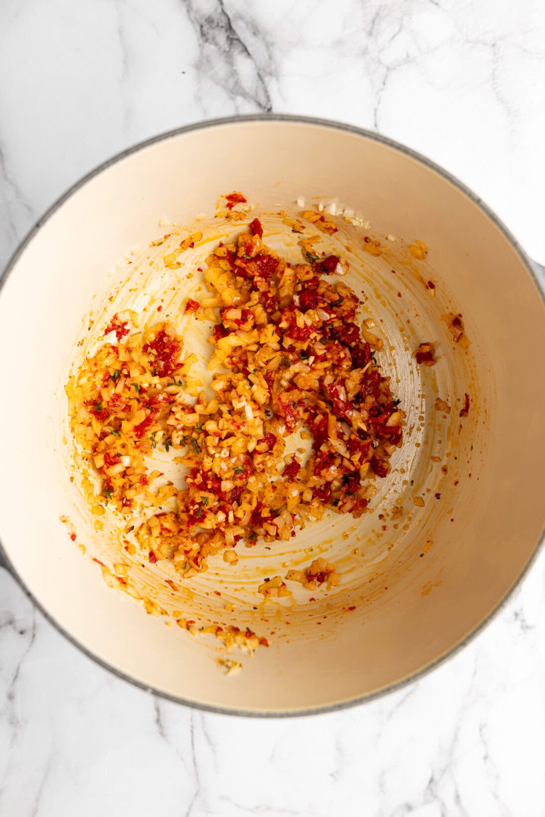 soup step by step: sautéing the onion garlic, herbs, and sun dried tomato