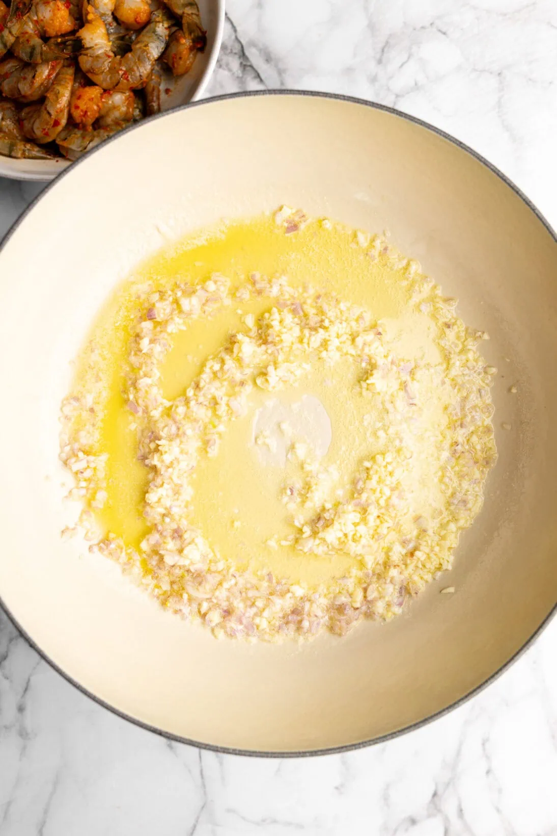 sautéing the garlic and minced shallot in a braiser
