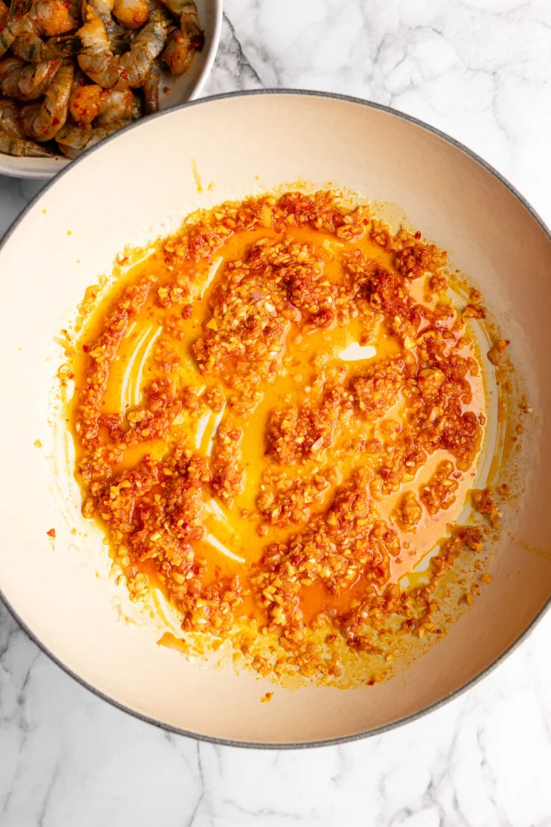 adding the harissa to the sautéd garlic and shallot