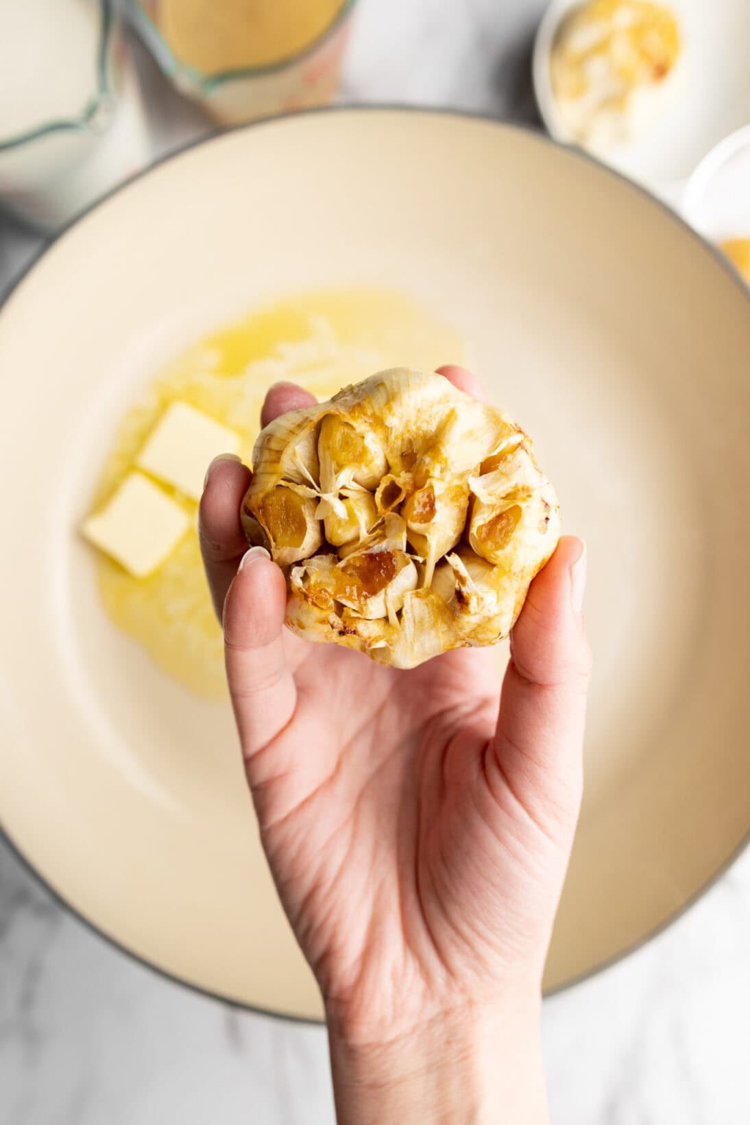holding a bulb of roasted garlic (pre-squeezed)