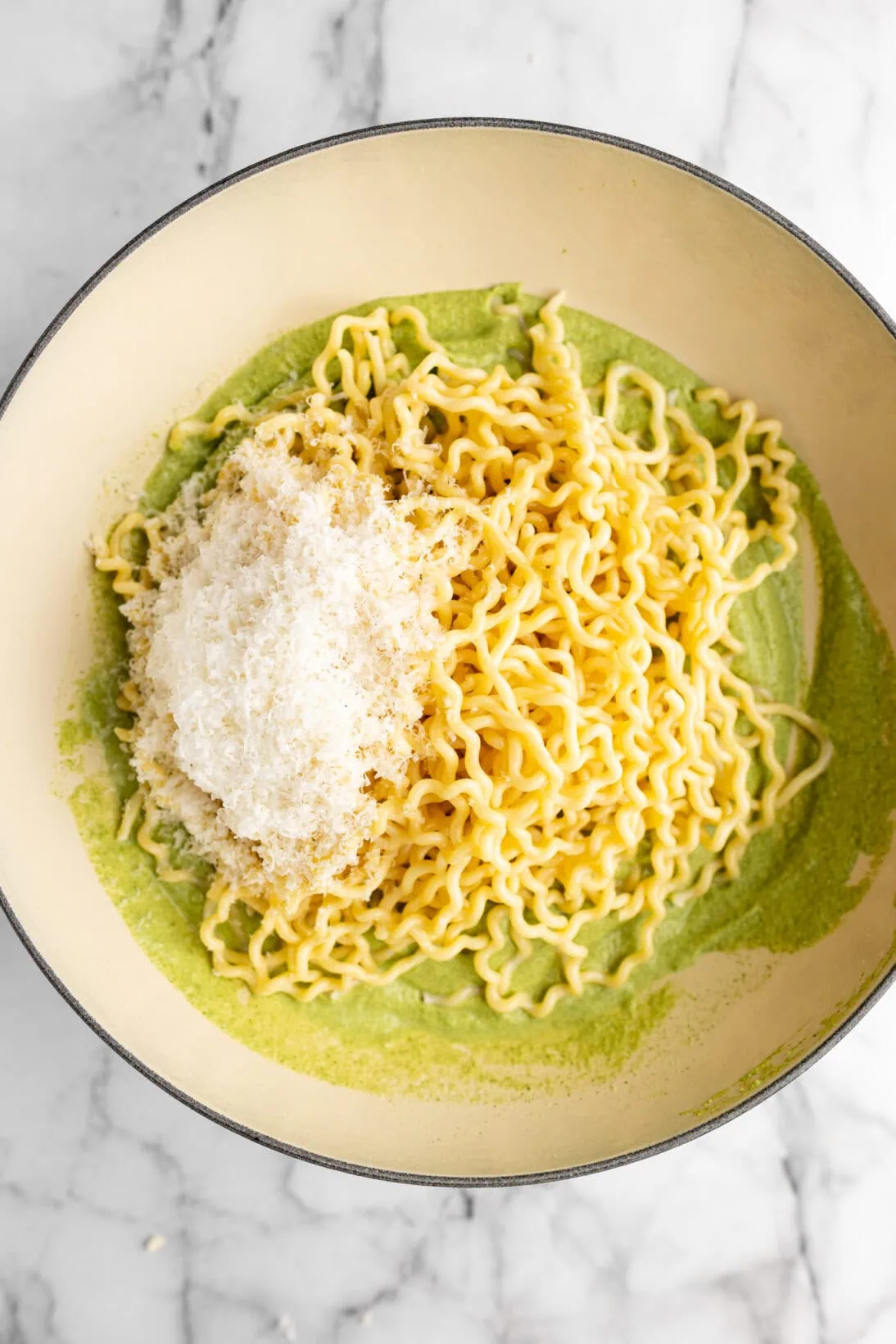 long fusilli on top of the artichoke and spinach sauce with freshly grated parm