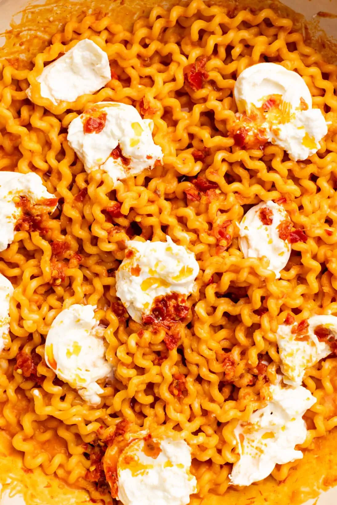 roasted tomato pasta sauce over long fusilli topped with creamy burrata