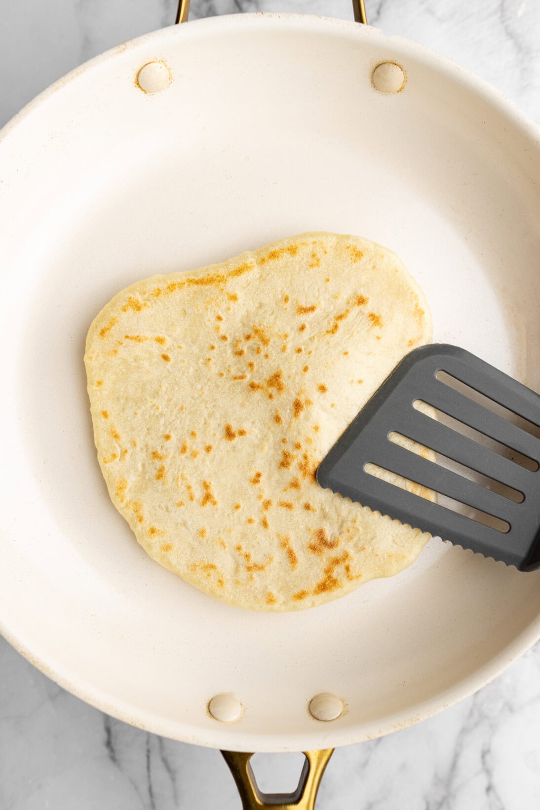 3rd-4th flip - developing air pocket - taking a spatula and lightly pressing on it to distribute the air.
