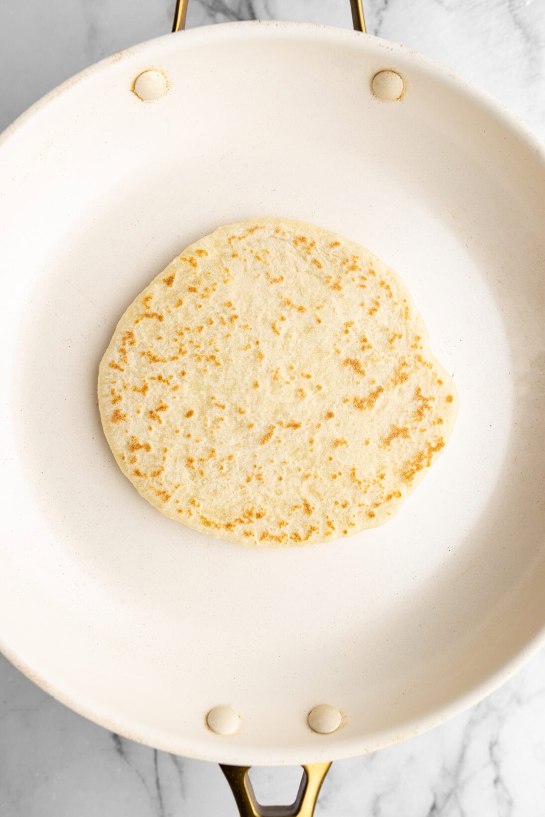 first flip of the raw homemade pita bread
