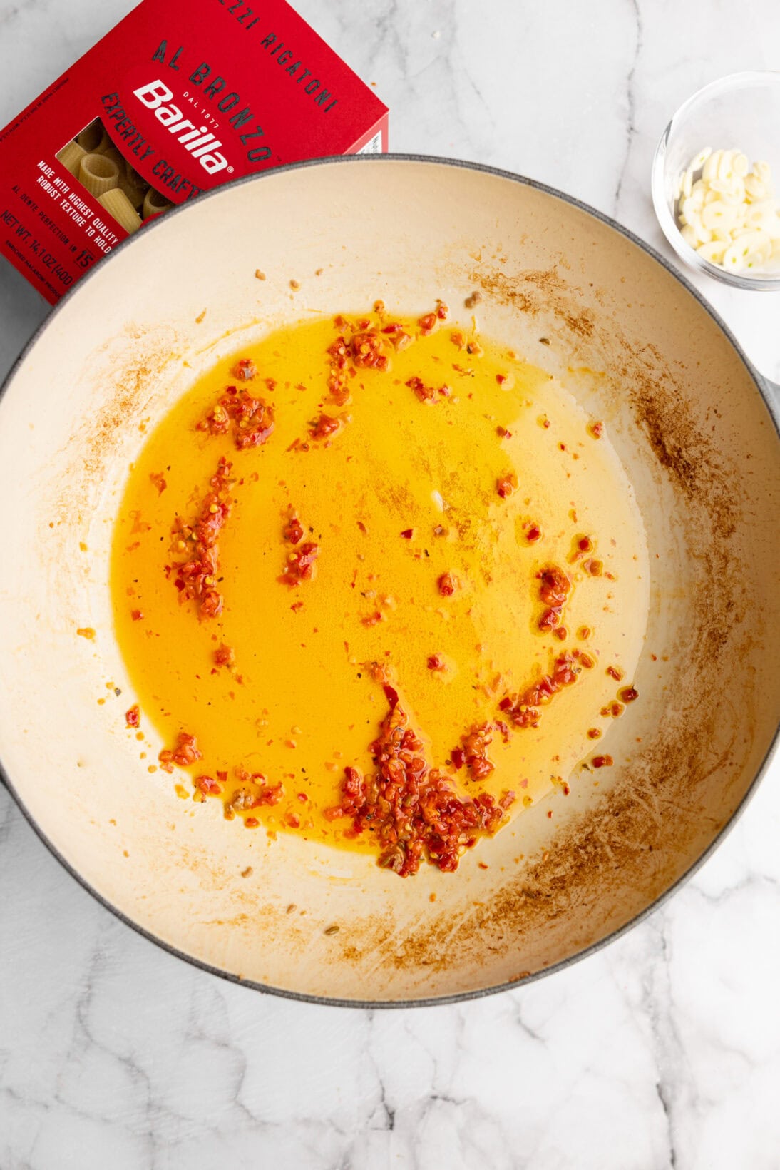 Calabrian chilis added to oil. 