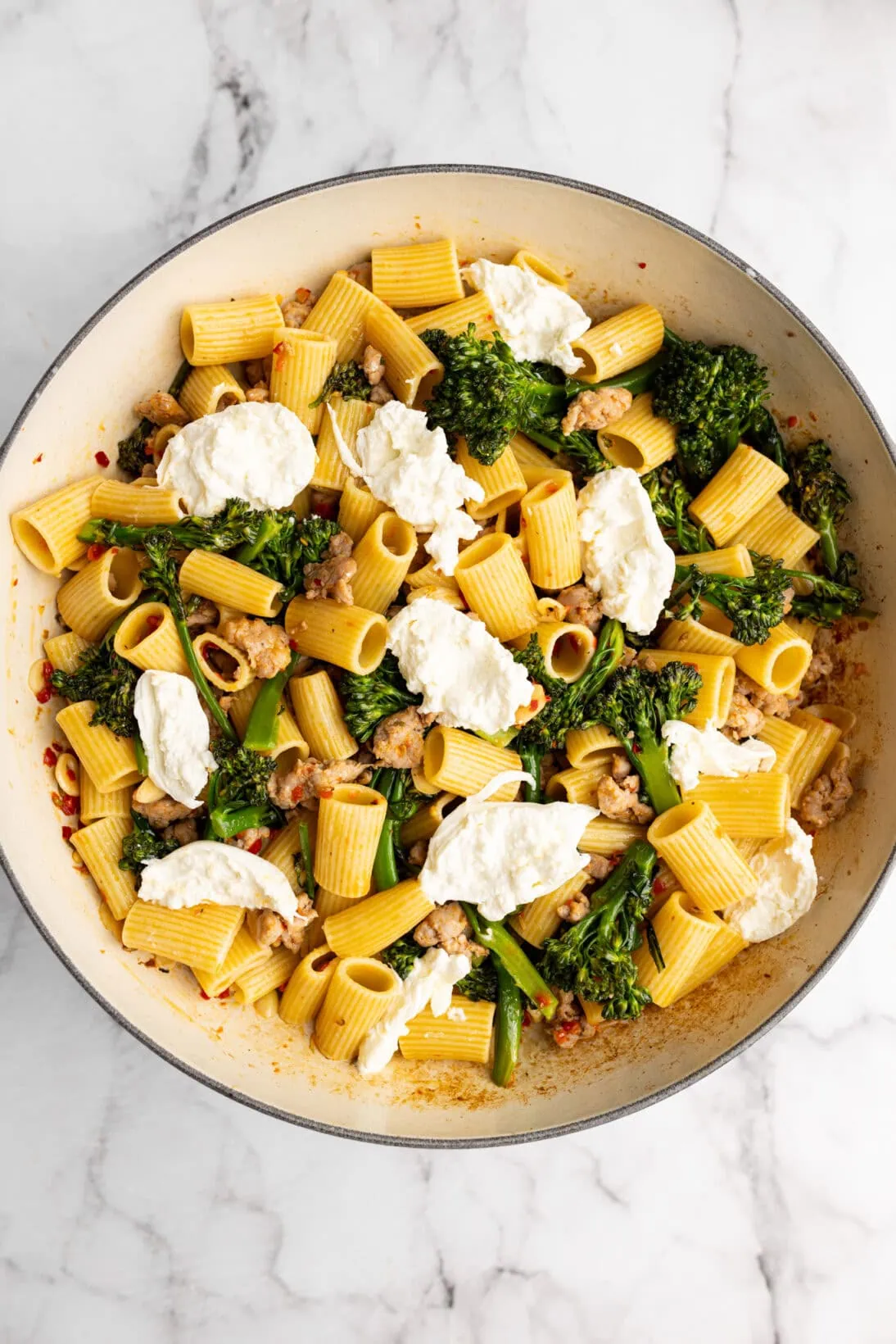 Italian sausage and broccolini pasta in a braiser.