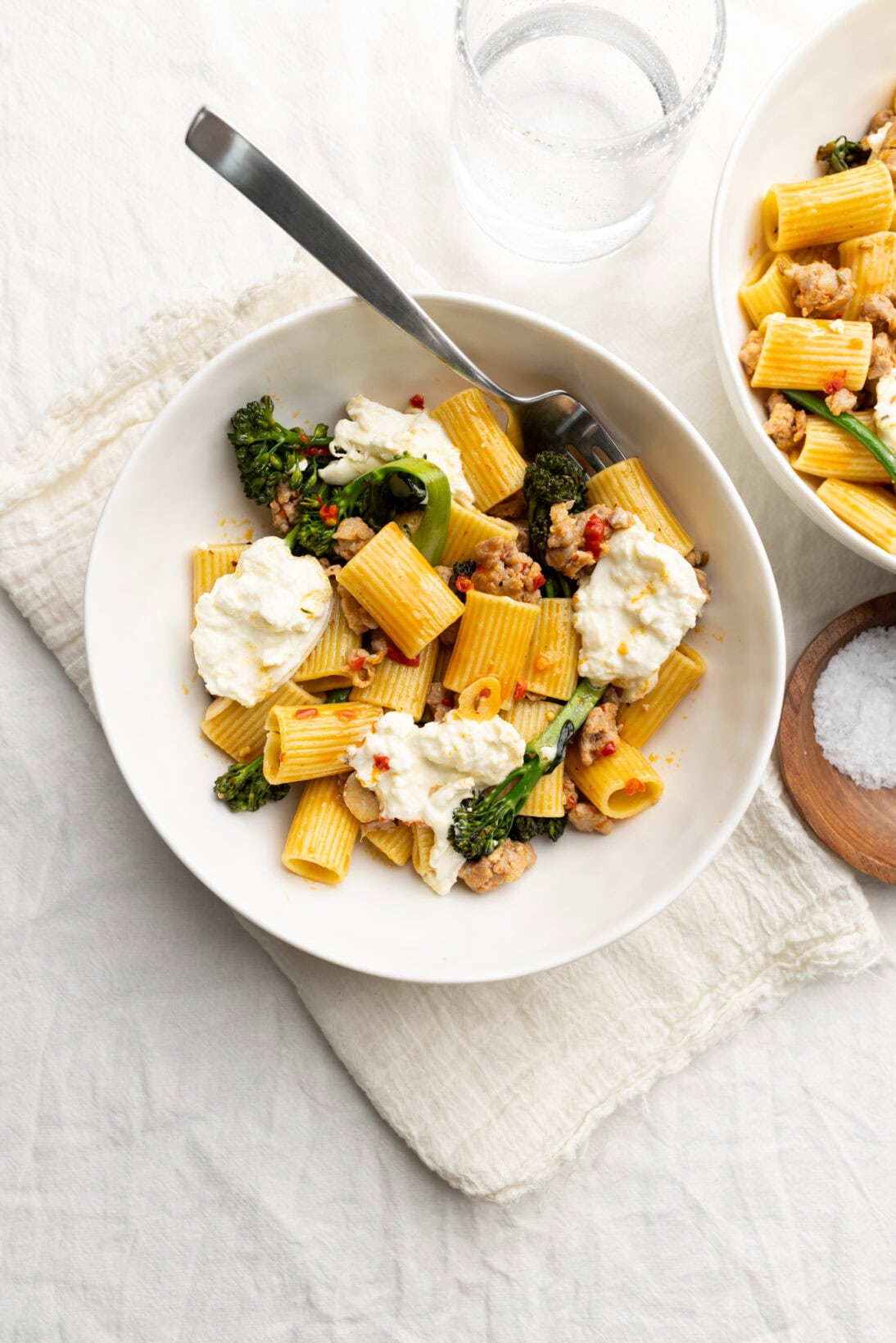 2 bowls of  Italian sausage and broccolini pasta.