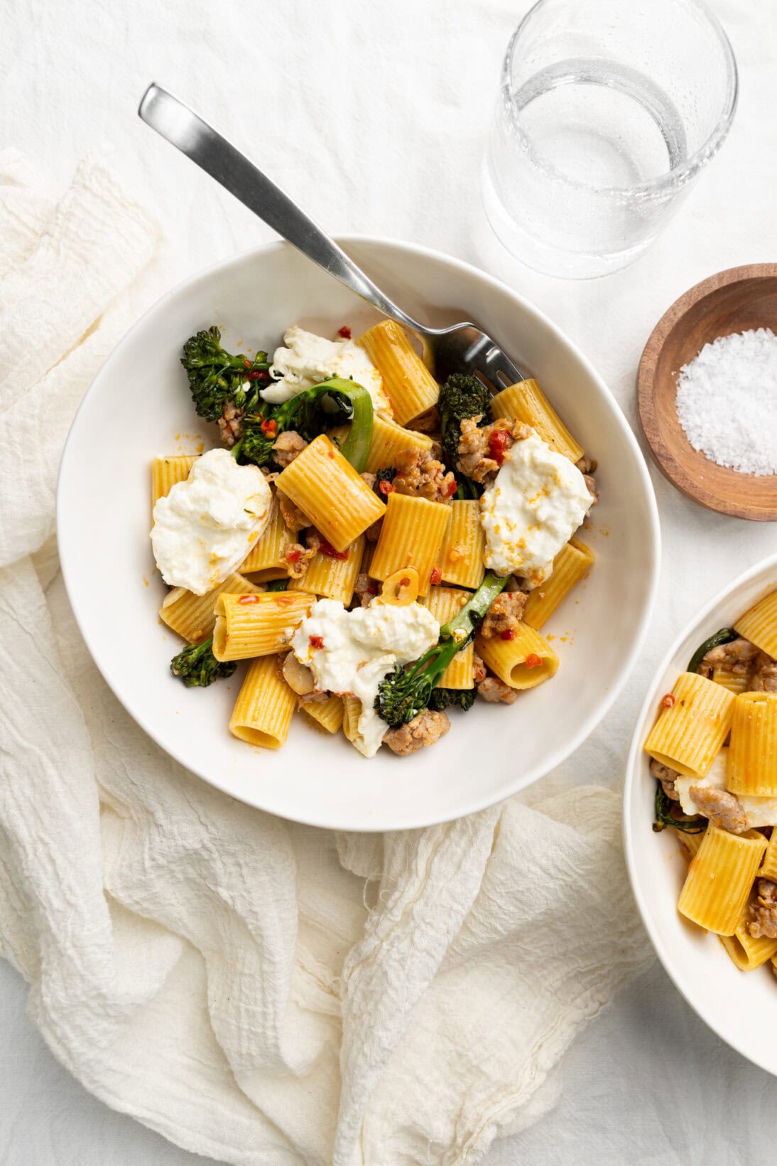 2 bowls of  Italian sausage and broccolini pasta.