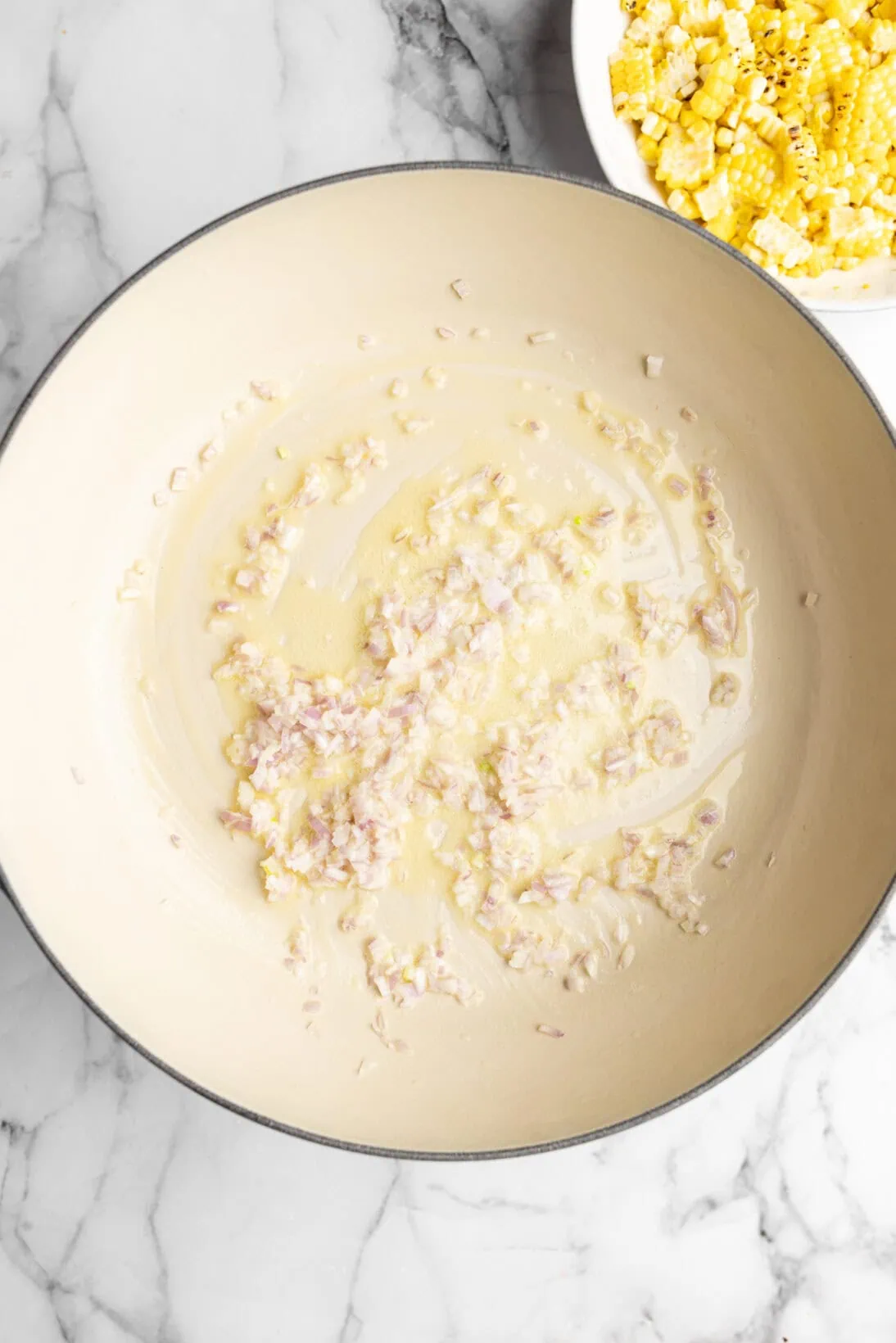 shallots cooking in butter in a braiser