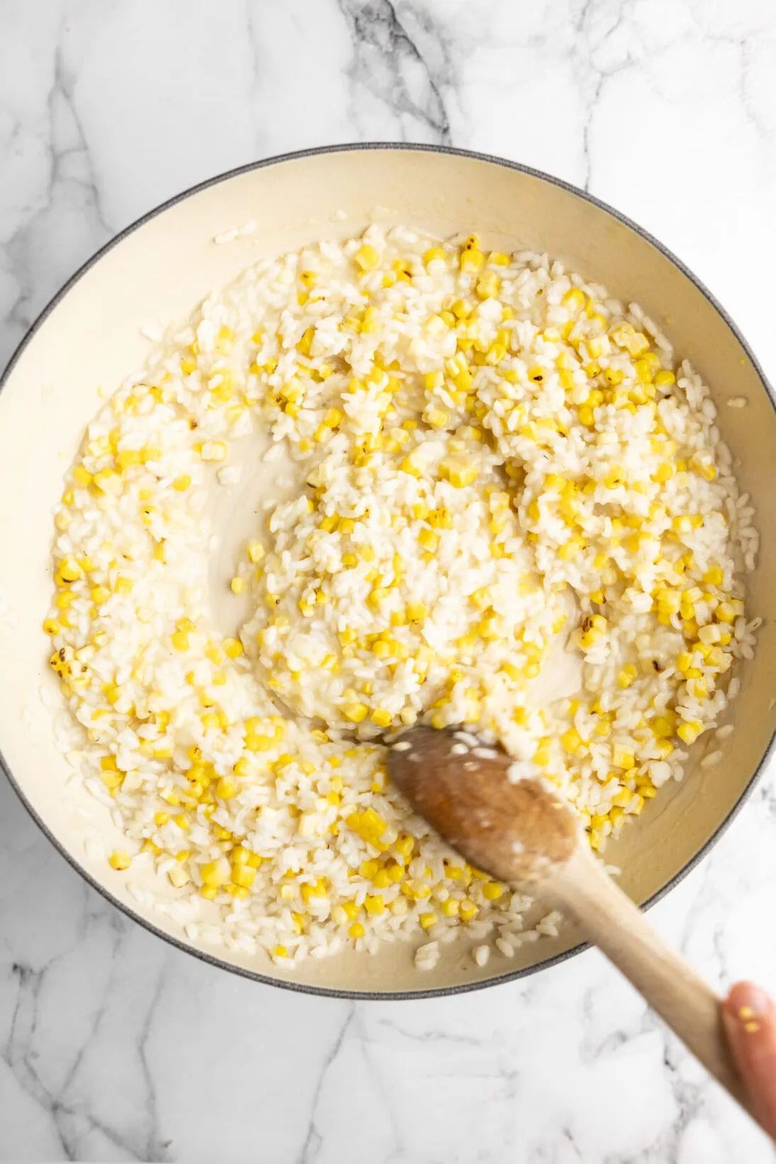 mixing the corn risotto