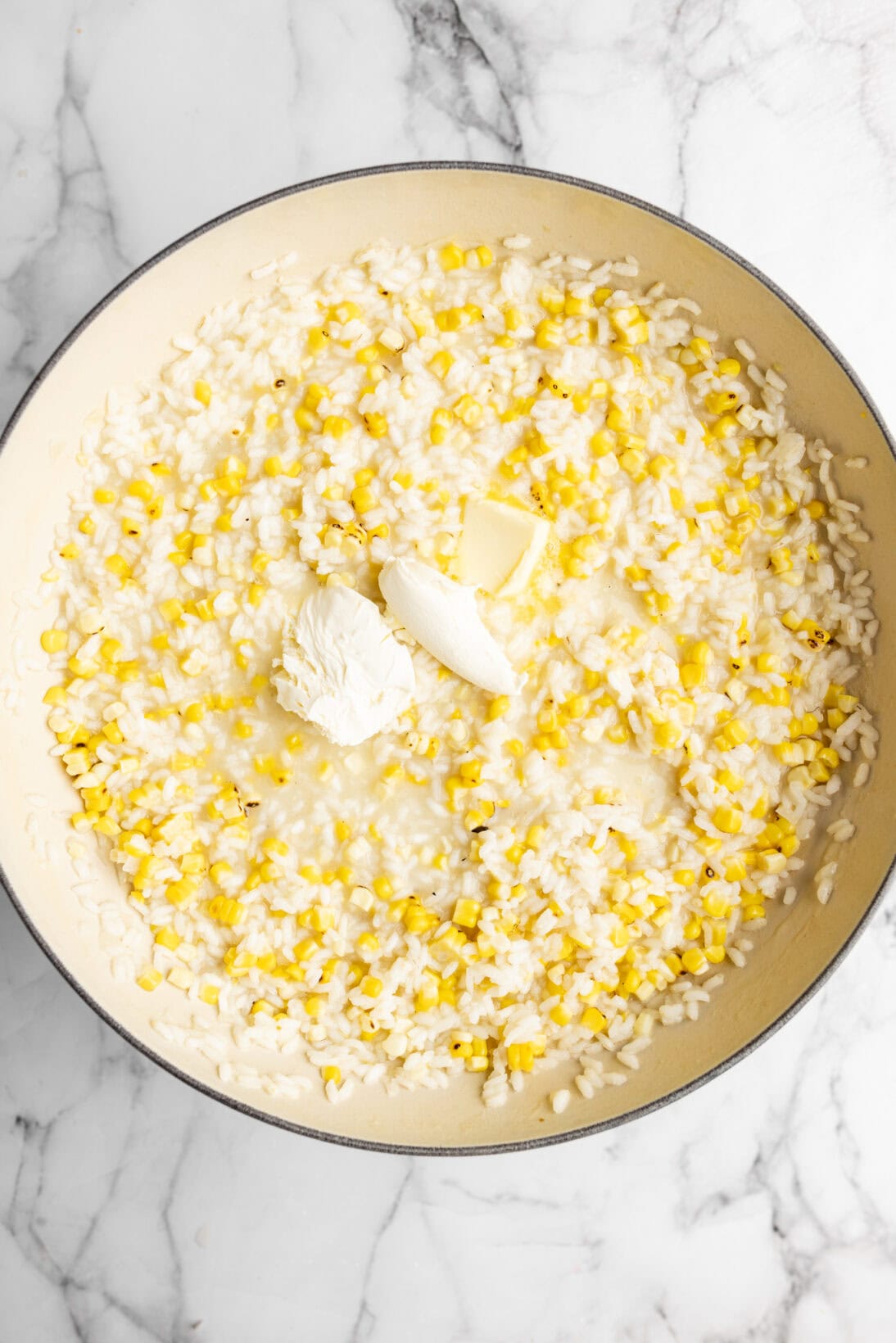 folding in the mascarpone cheese, corn, and another tablespoon of butter.