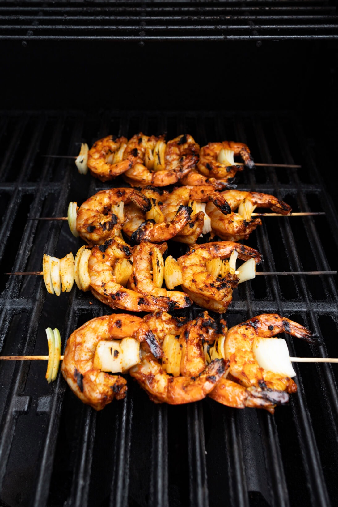 skewers of peri-peri shrimp on the grill