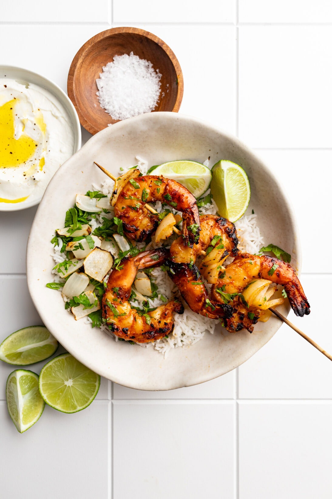 grilled peri-peri shrimp topped with cilantro over rice.