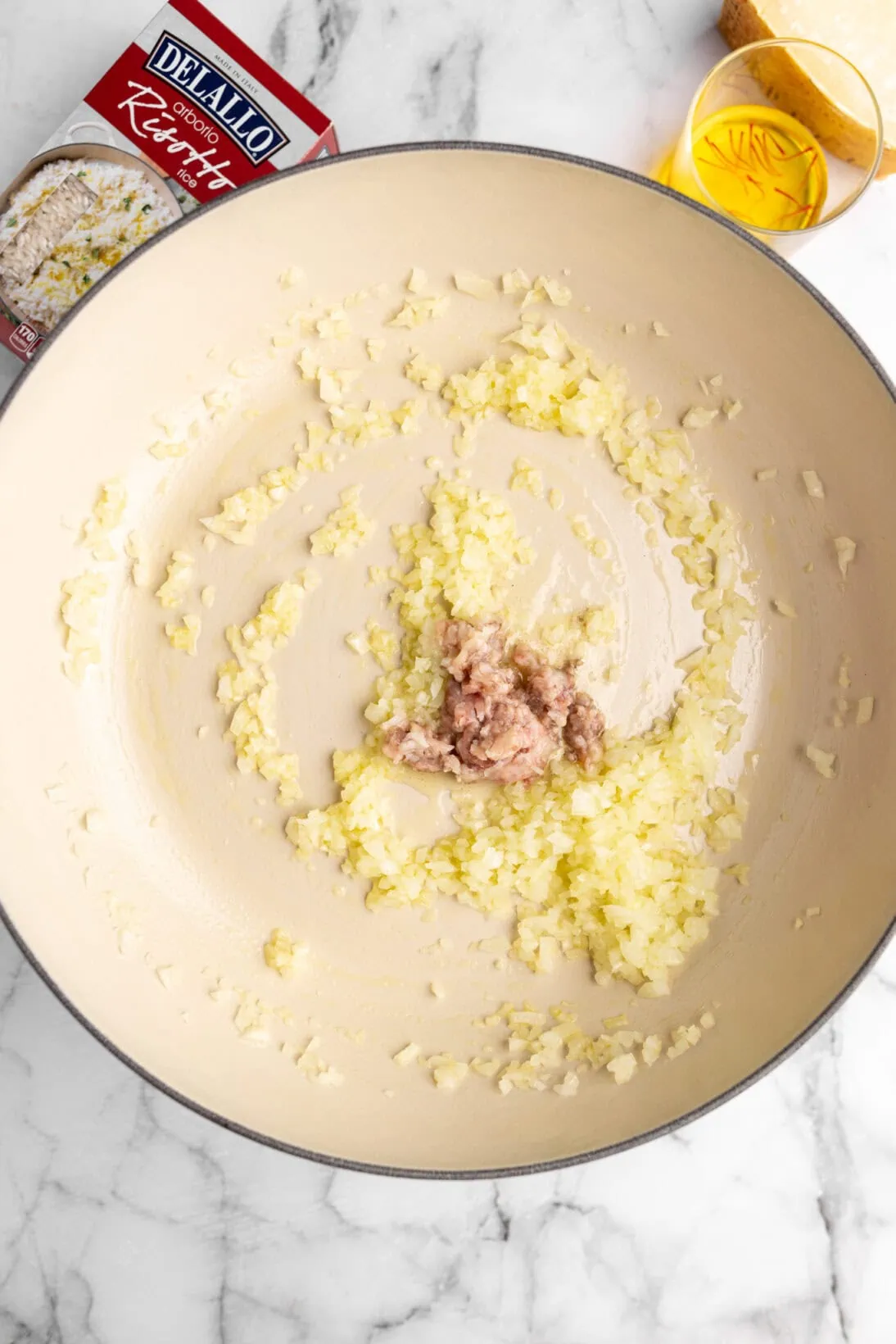 cooking risotto alla milanese - cooking the onions and marrow in olive oil