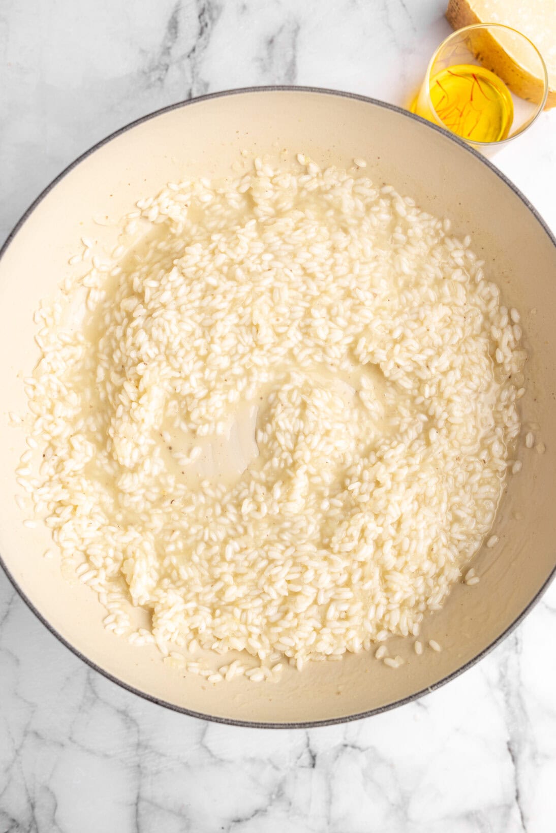 cooking risotto alla milanese - the broth being absorbed from the rice, this is the point to add more broth