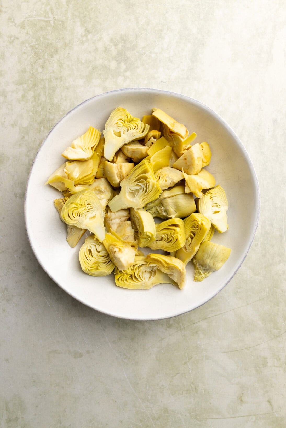 a bowl of canned artichoke heart quarters and halves. 