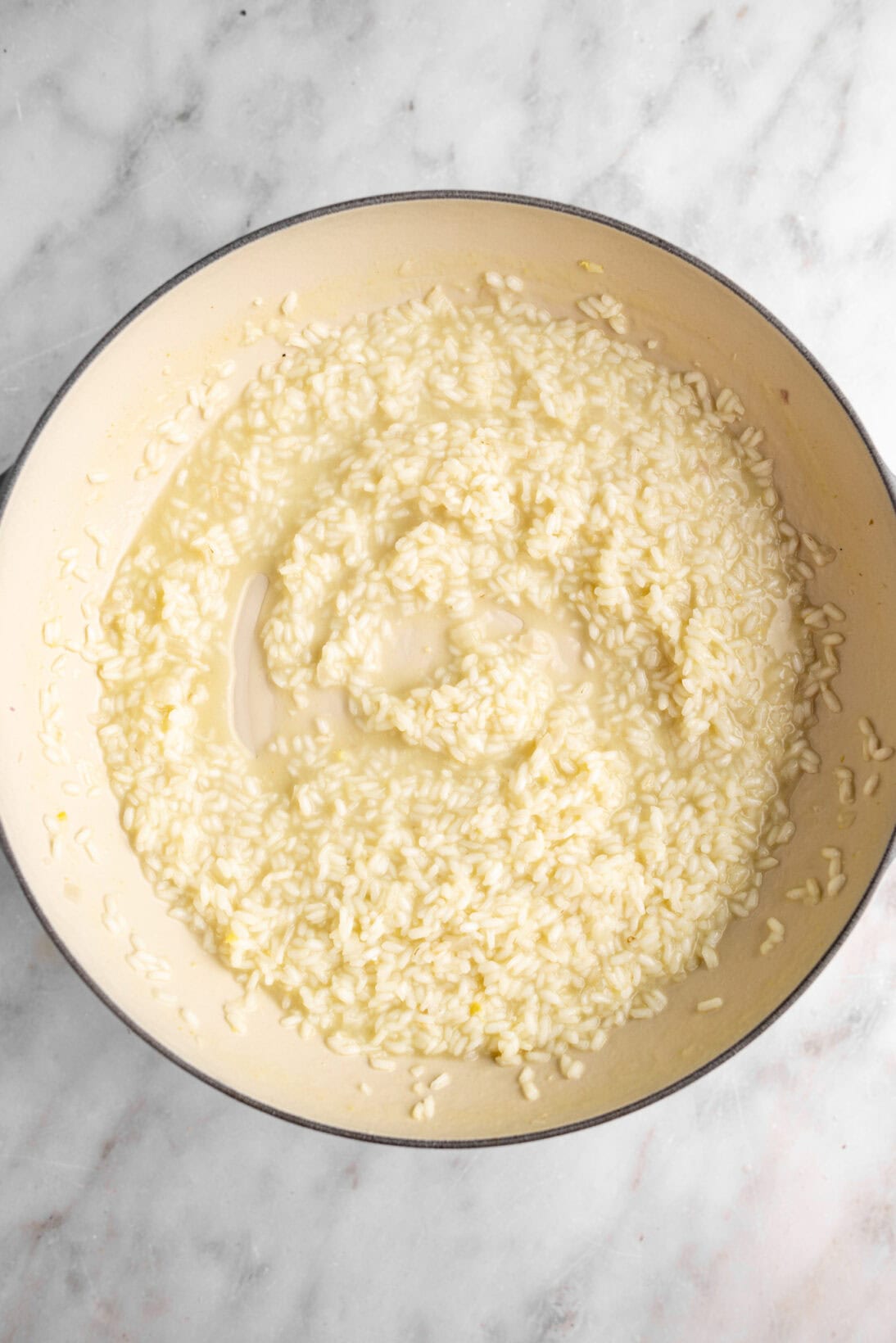 making risotto: cooking the risotto slowly.