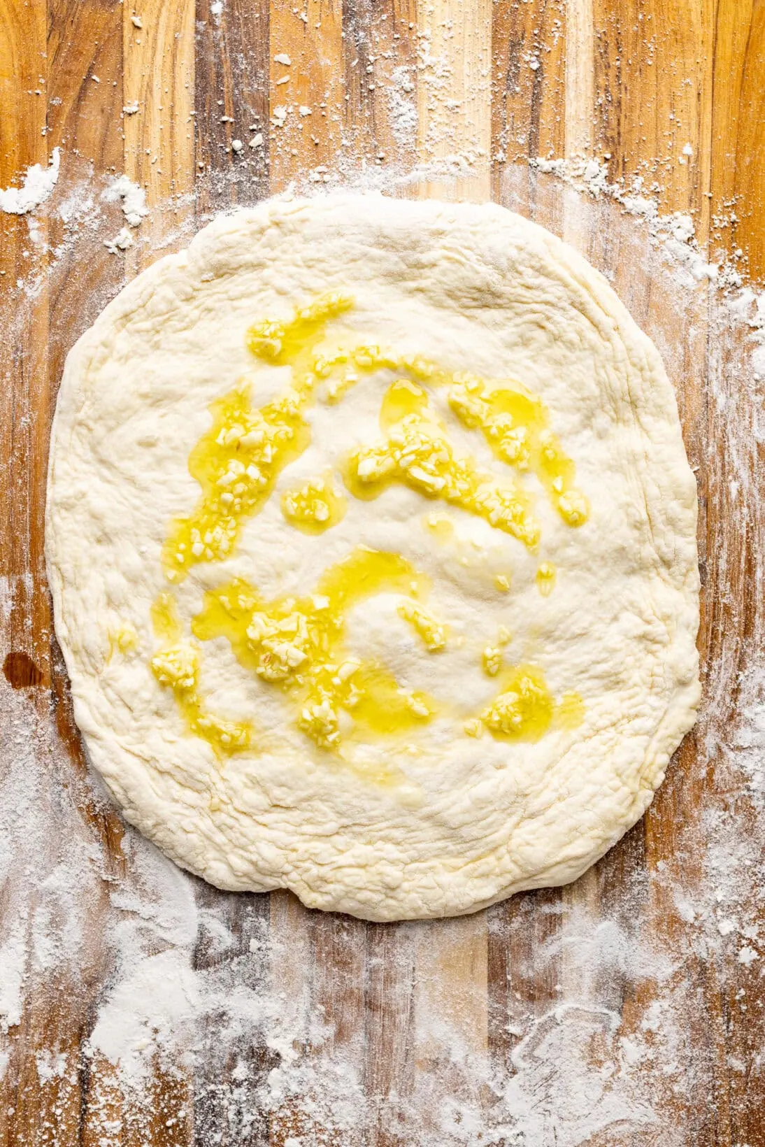 raw pizza dough with garlic oil
